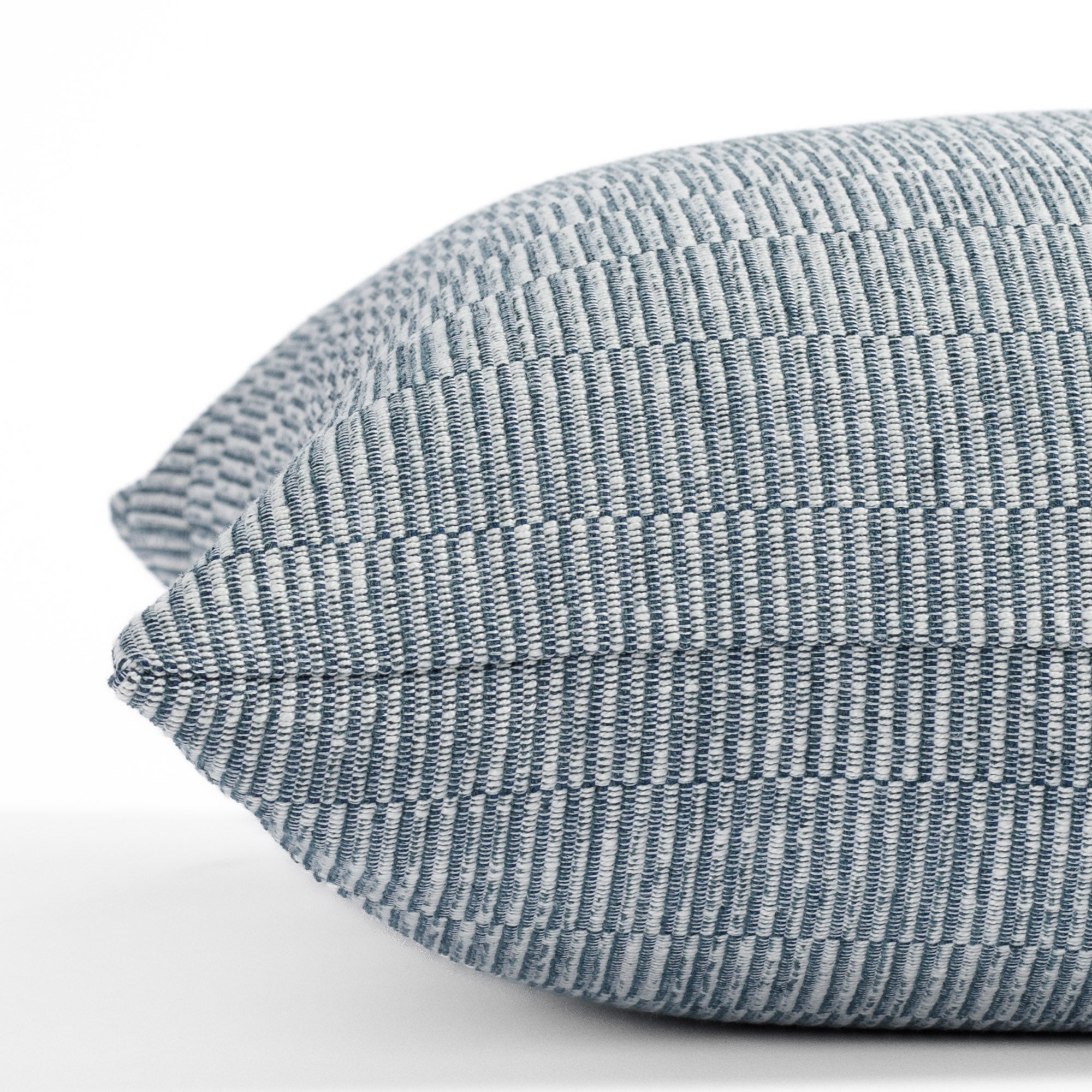 a blue tonal stripe throw pillow : close up side view