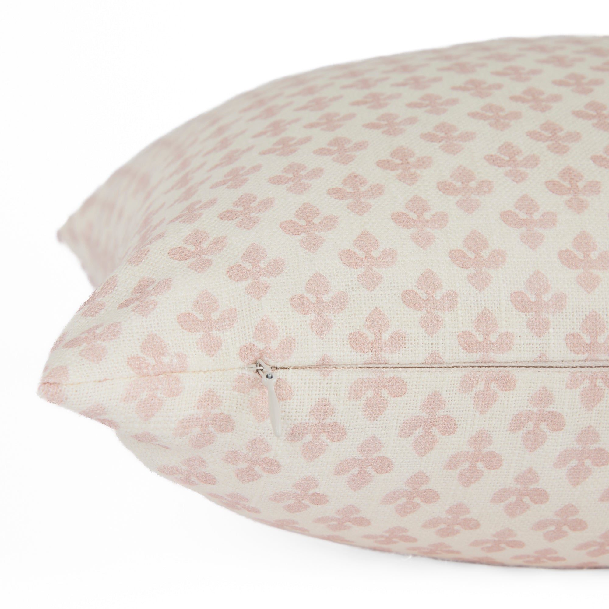 Side zipper detail of Lyra 14x20 Blush lumbar pillow by Tonic Living — linen-blend pillow with a white and light pink floral block print.