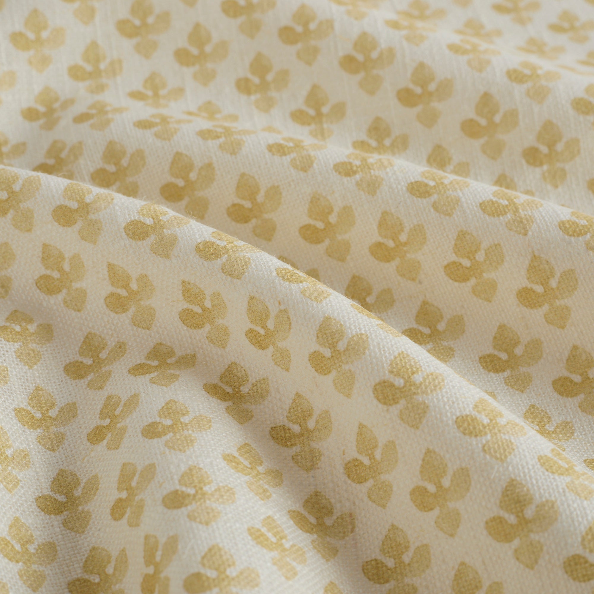 Close-up of Lyra Fabric, Butter Yellow by Tonic Living — lightweight linen-blend fabric with a detailed floral block print.
