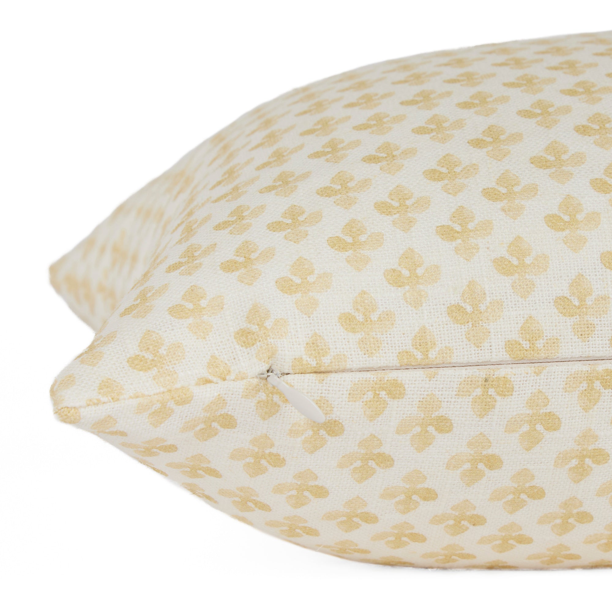 Side zipper detail of Lyra 14x20 Butter Yellow lumbar pillow by Tonic Living — white and yellow printed linen-blend fabric.