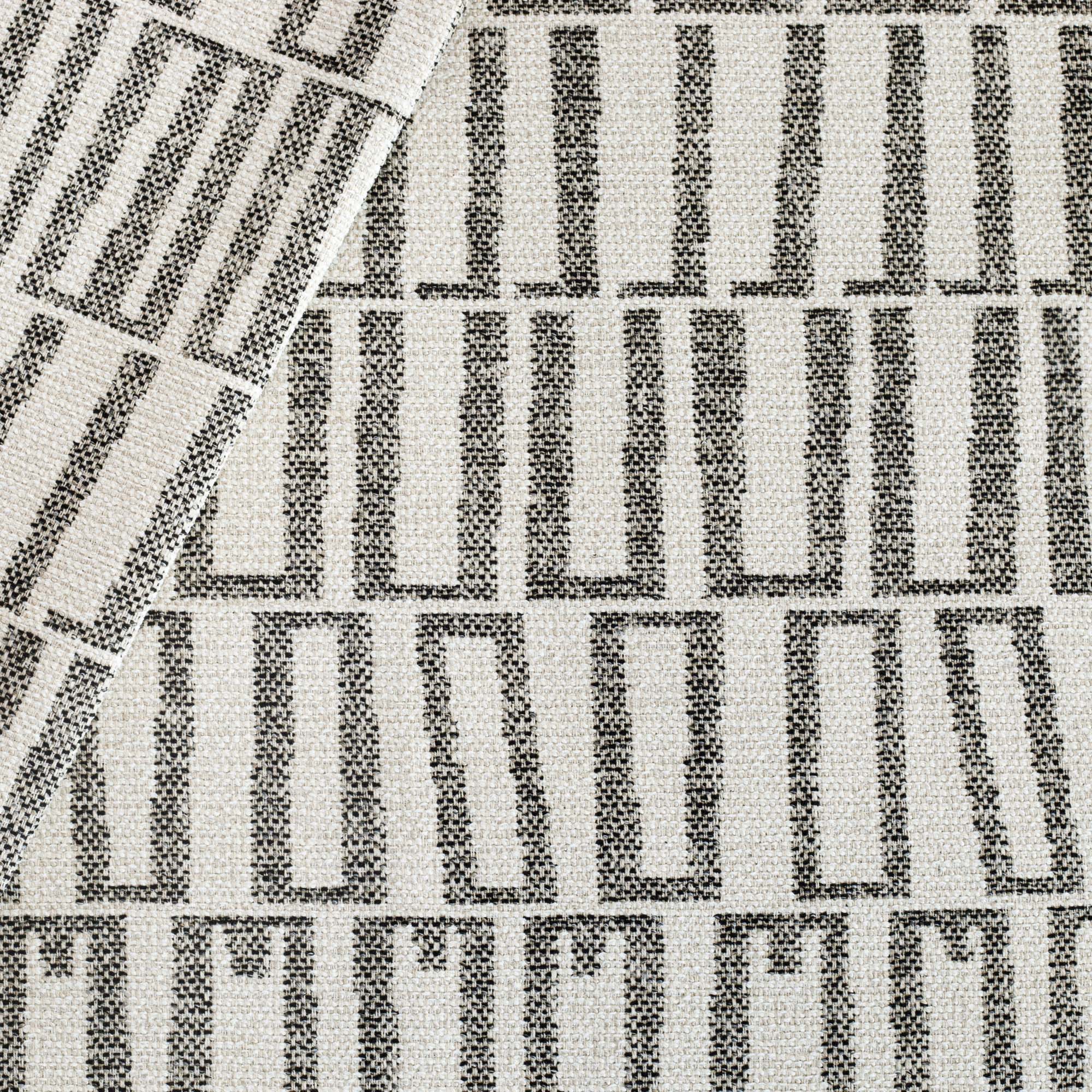 Mallia InsideOut fabric Carbon, a black and sand beige abstract geometric patterned outdoor fabric from Tonic Living