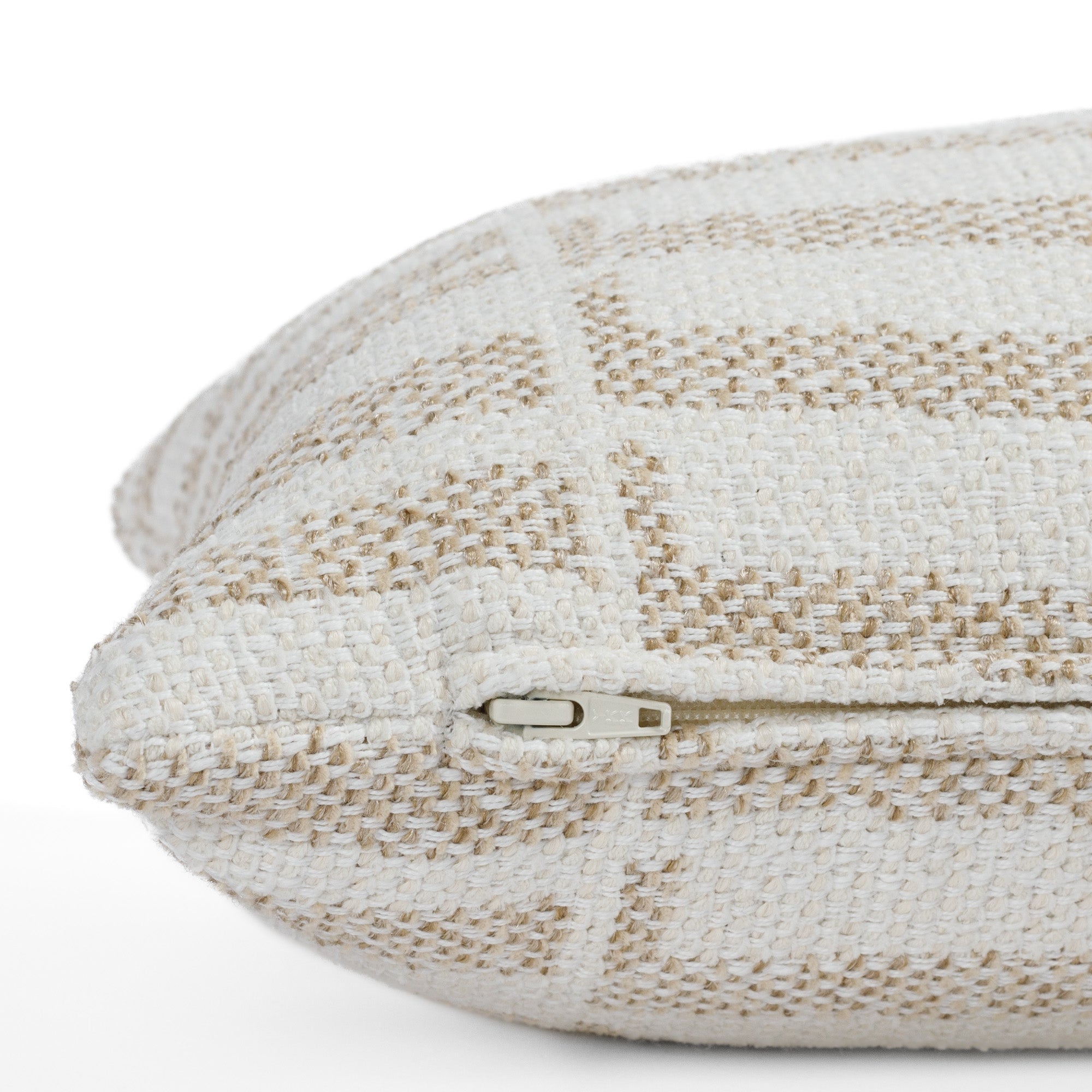 Side detail of Tonic Living’s Mallia 12x24 lumbar toss pillow, highlighting the hidden zipper and easy-clean, fade-resistant fabric in a warm neutral palette.