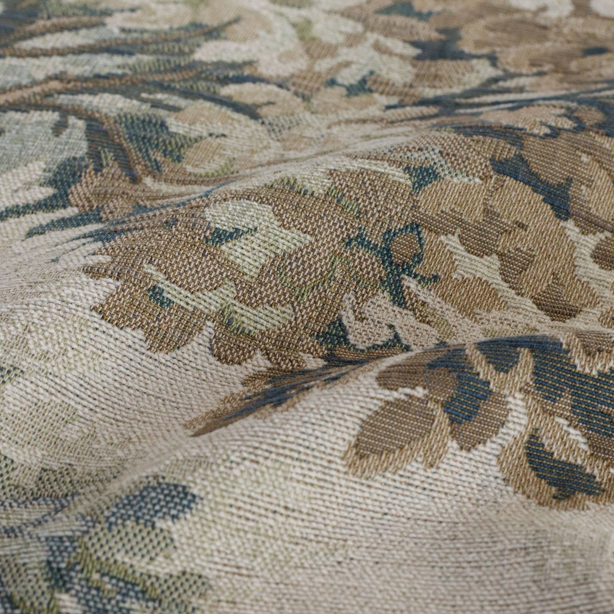 Close-up of Tonic Living Manor Tapestry Moss British-style upholstery fabric with leafy trees.