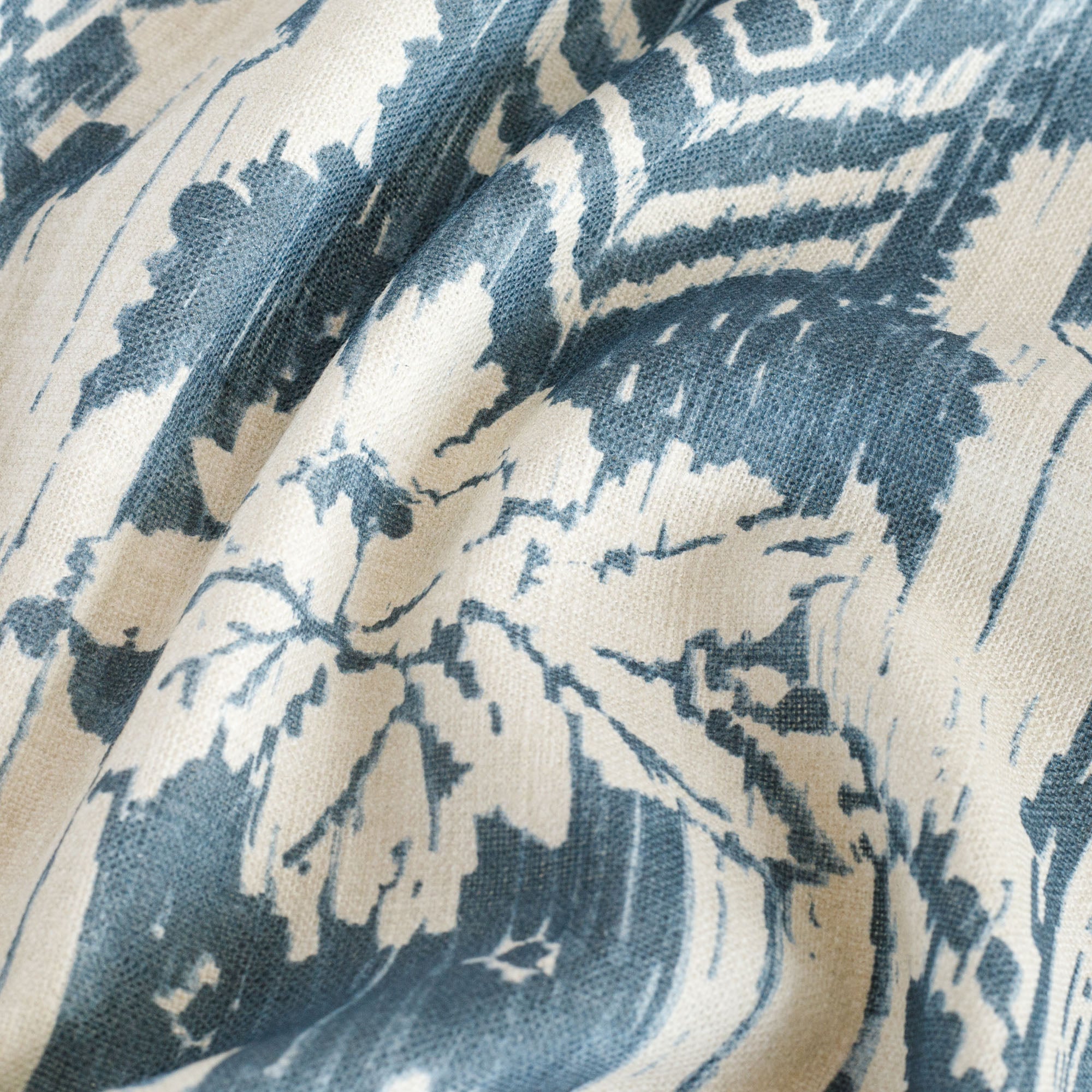 a cream and blue floral ikat print home decor fabric