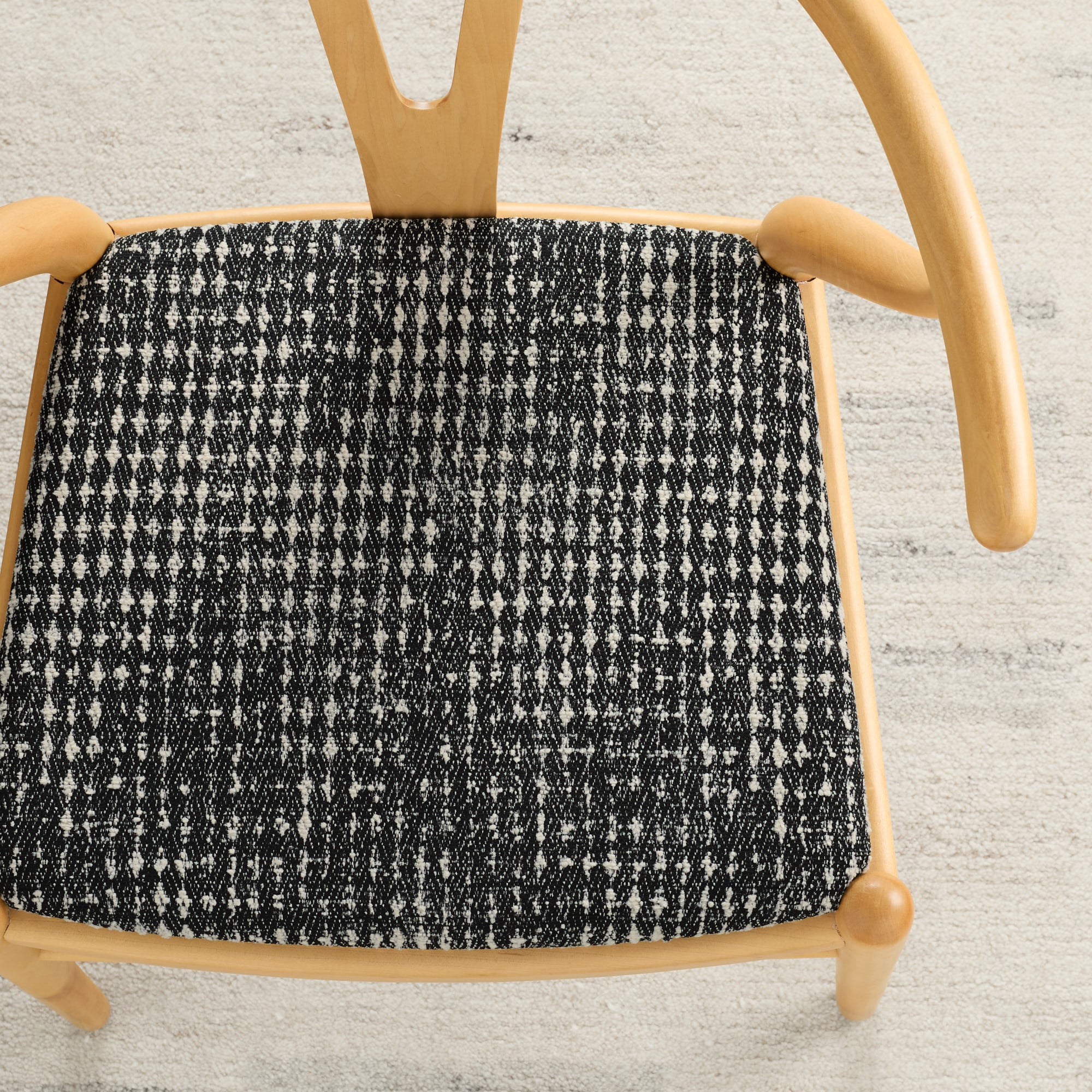 Dining chair upholstered in Otto Fabric, Domino by Tonic Living — bold black and white geometric upholstery fabric.