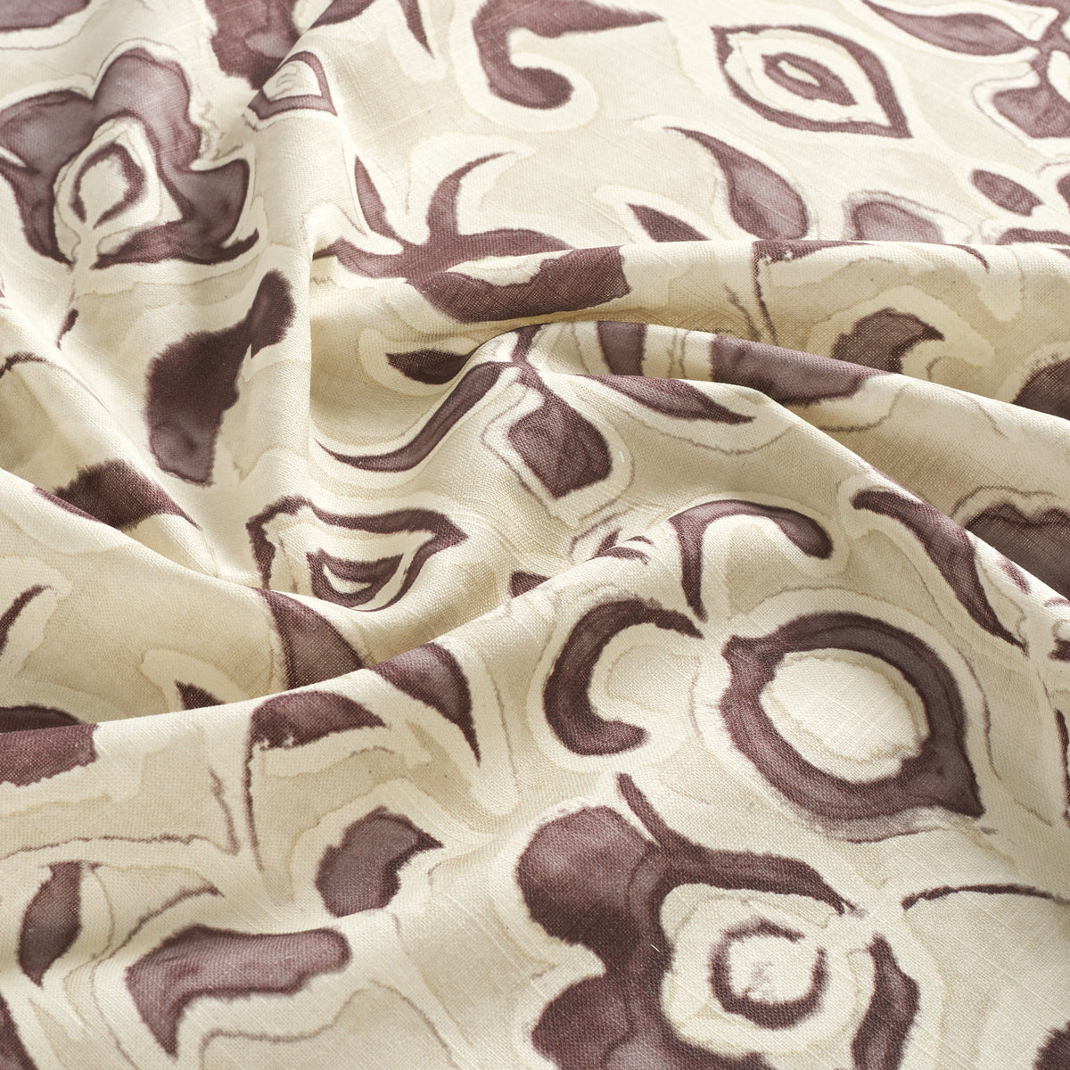 Tonic Living Paloma Mauve drapery fabric featuring bold muted purple blooms and scrolling leaves on a neutral oatmeal background.