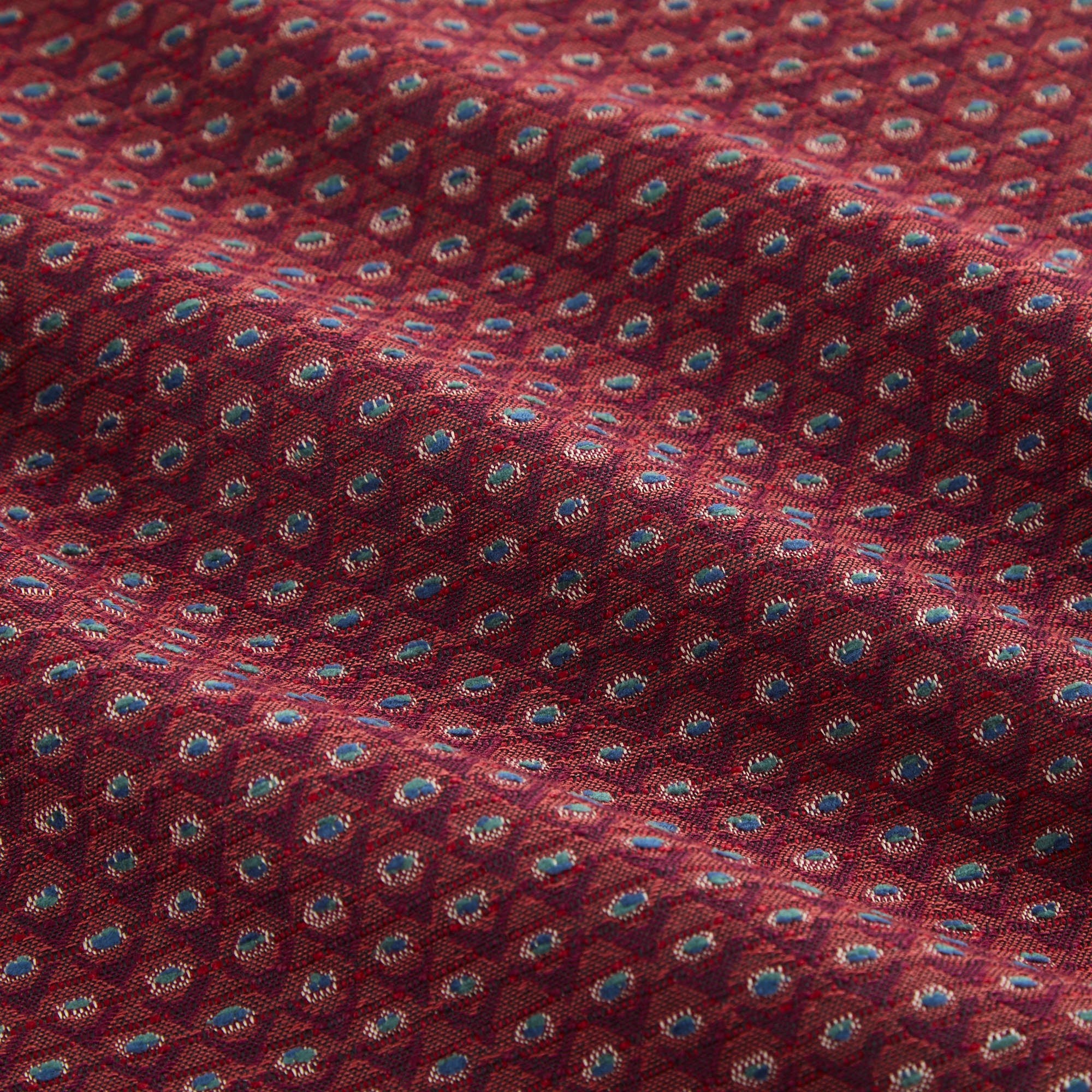 Detailed view of Pembrook Fabric Merlot, rich burgundy home decor fabric with intricate small-scale diamond weave from Tonic Living.