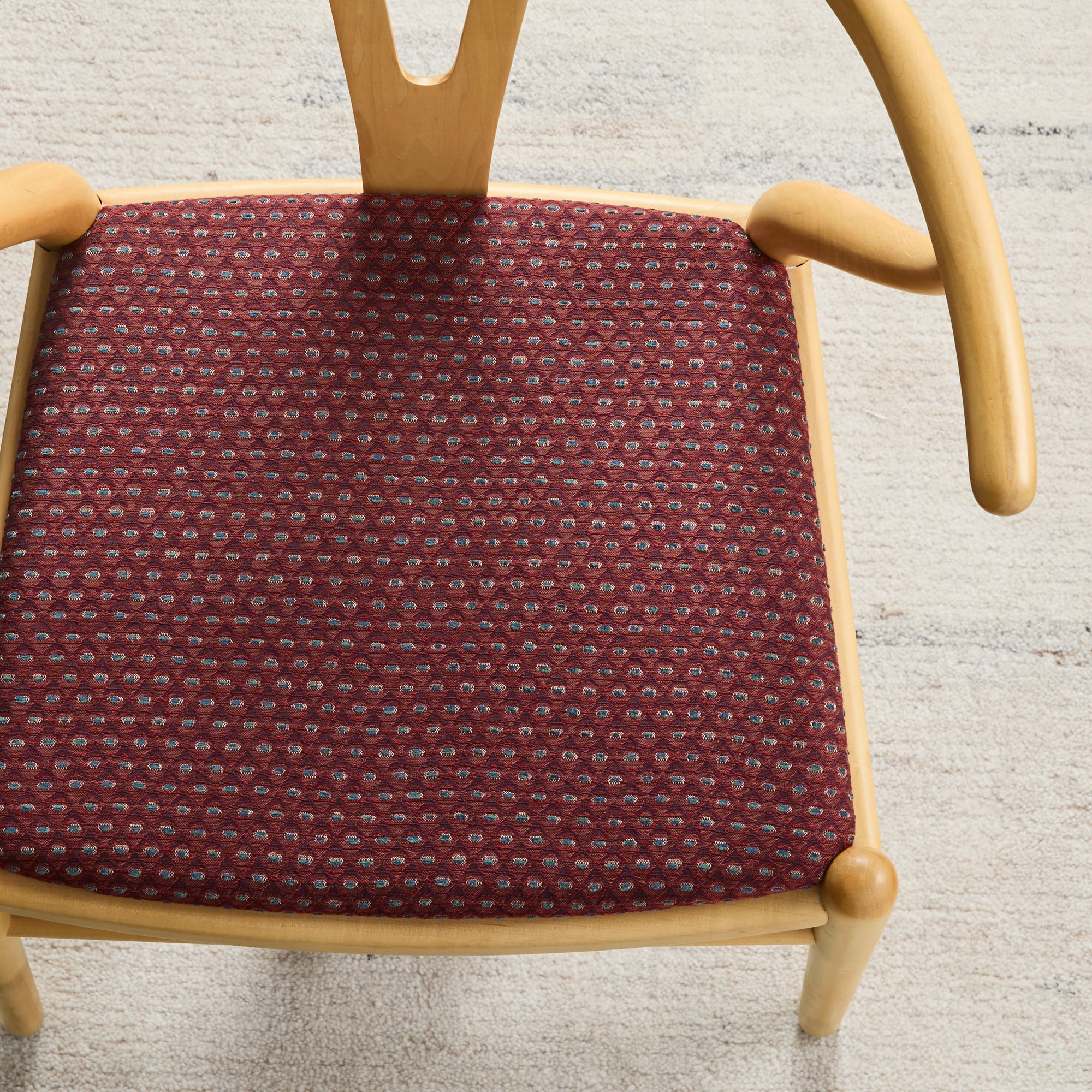 Dining chair upholstered in Pembrook Fabric Merlot, a burgundy home decor fabric with geometric diamond design from Tonic Living.