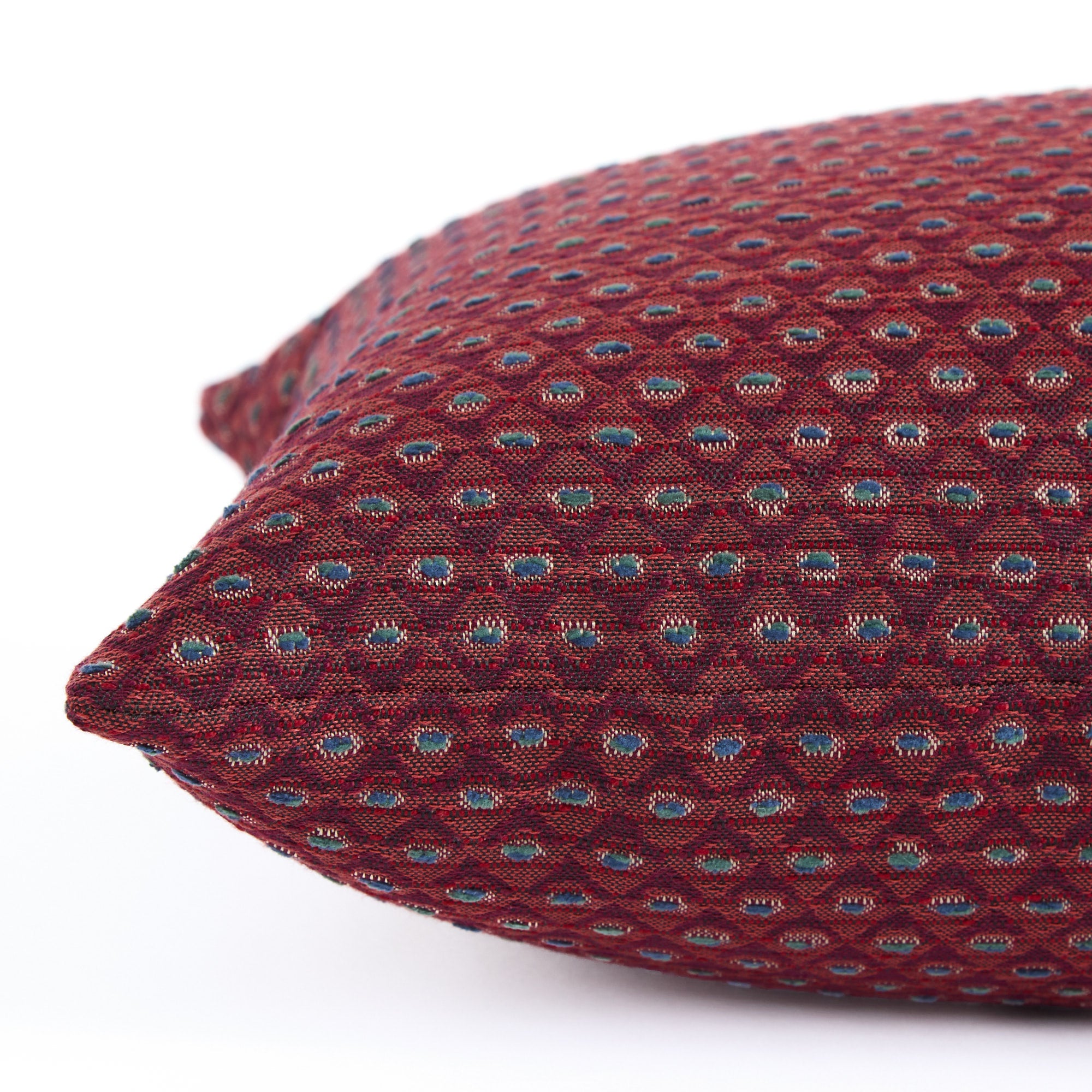 Detailed side view of Pembrook 14x20 burgundy red lumbar cushion with woven diamond motif, Tonic Living.