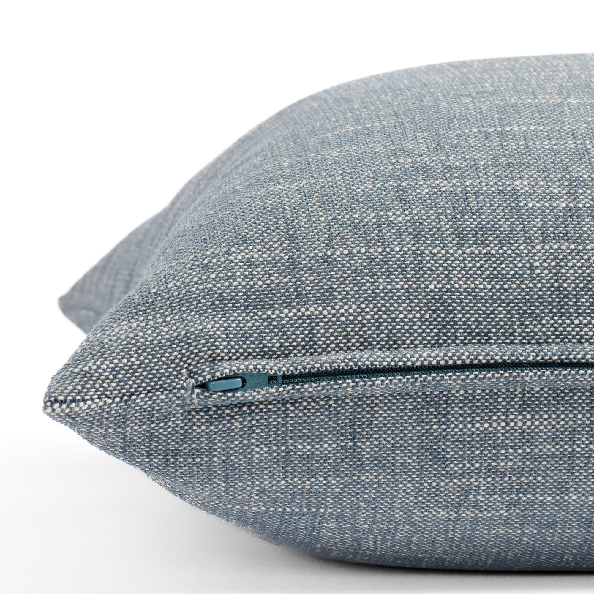 a soft stone blue throw pillow : close up zipper view