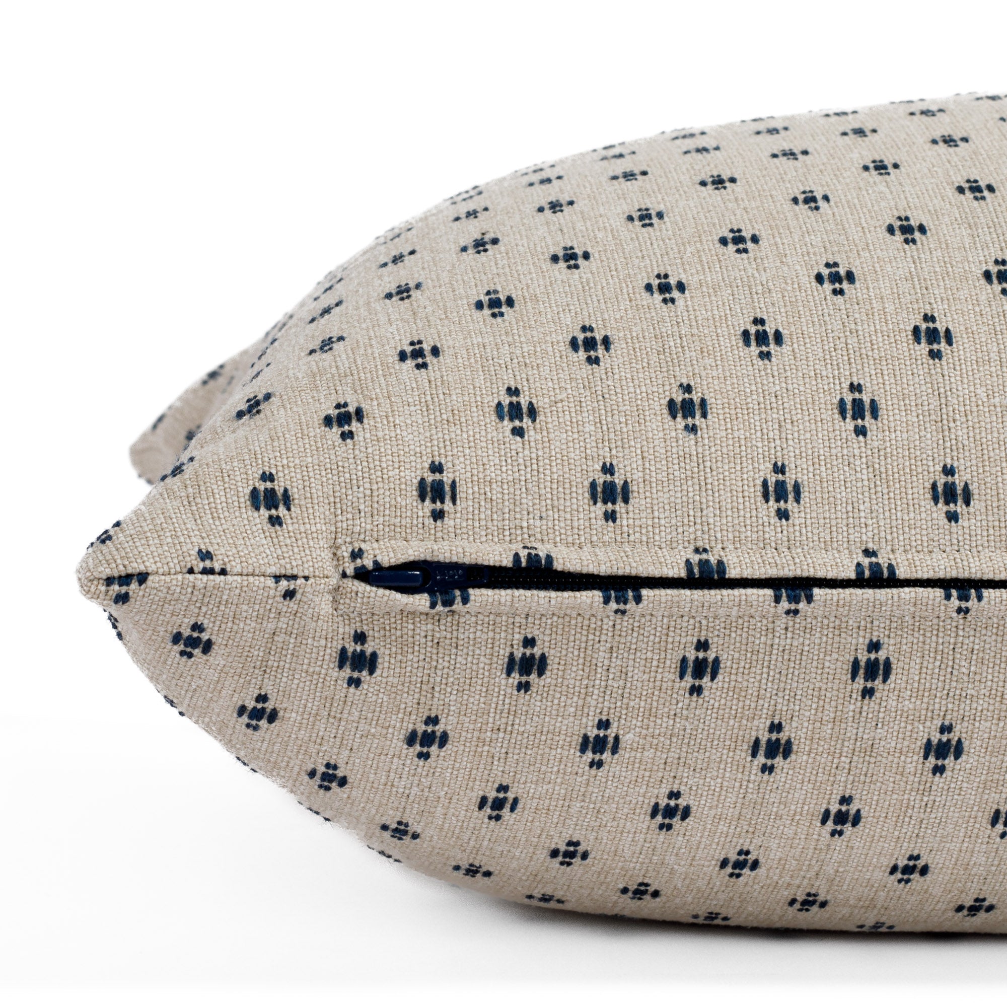 Pierce 16x42 Bolster Pillow, a taupe and dark blue dotted pillow from Tonic Living: close up zipper view.