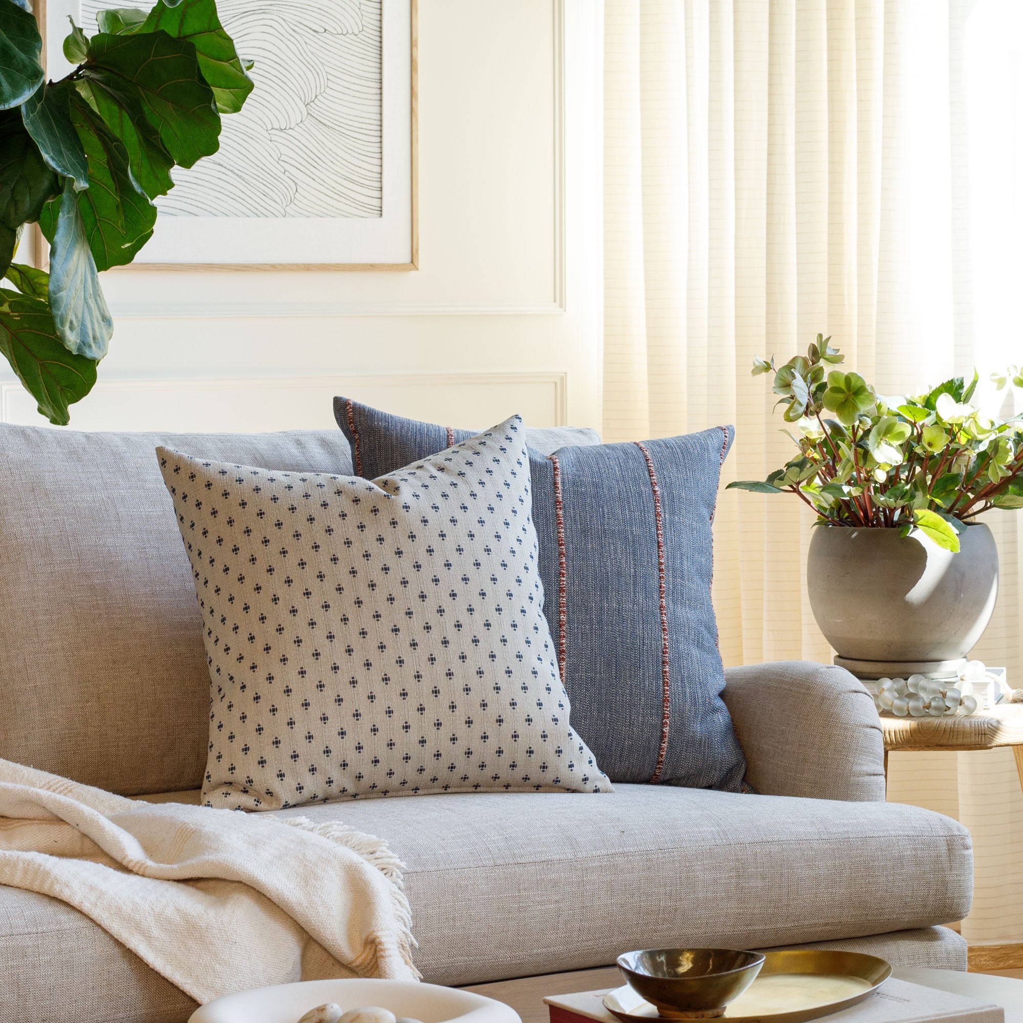 Living room with Pierce Navy blue and Brooklyn Stripe Navy & Red pillows styled on a sofa – Tonic Living