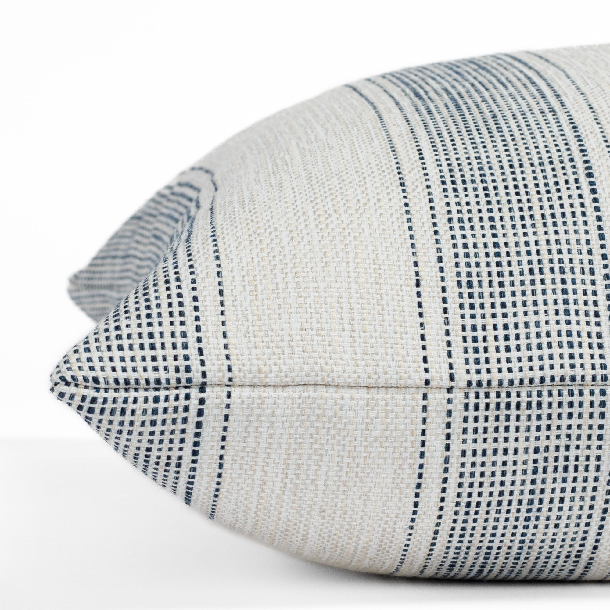 Revitalize navy blue and off-white striped indoor/outdoor throw pillow from Tonic Living, close-up side view.