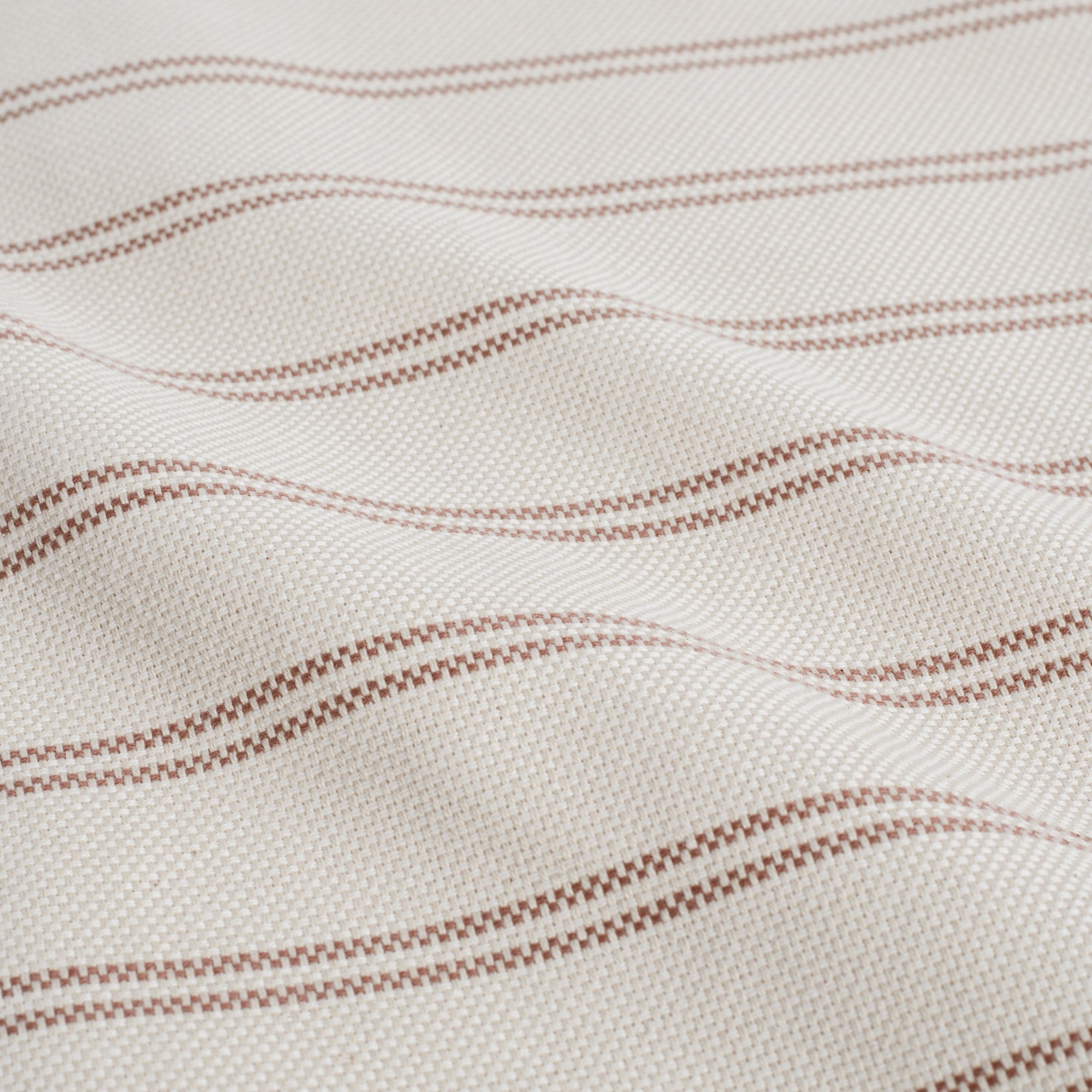 Close up of Tonic Living Rexton Stripe Merlot fabric showing ticking stripes in deep red and beige, durable upholstery material.