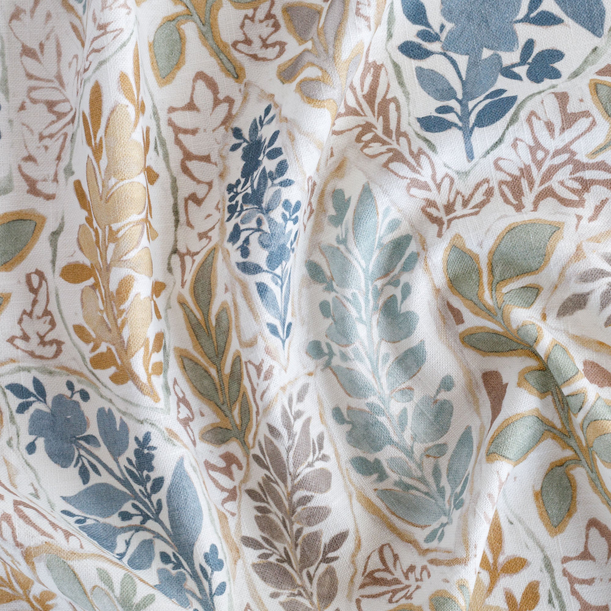 an aqua, sage, marigold, mauve and stone blue watery floral print fabric : close up
