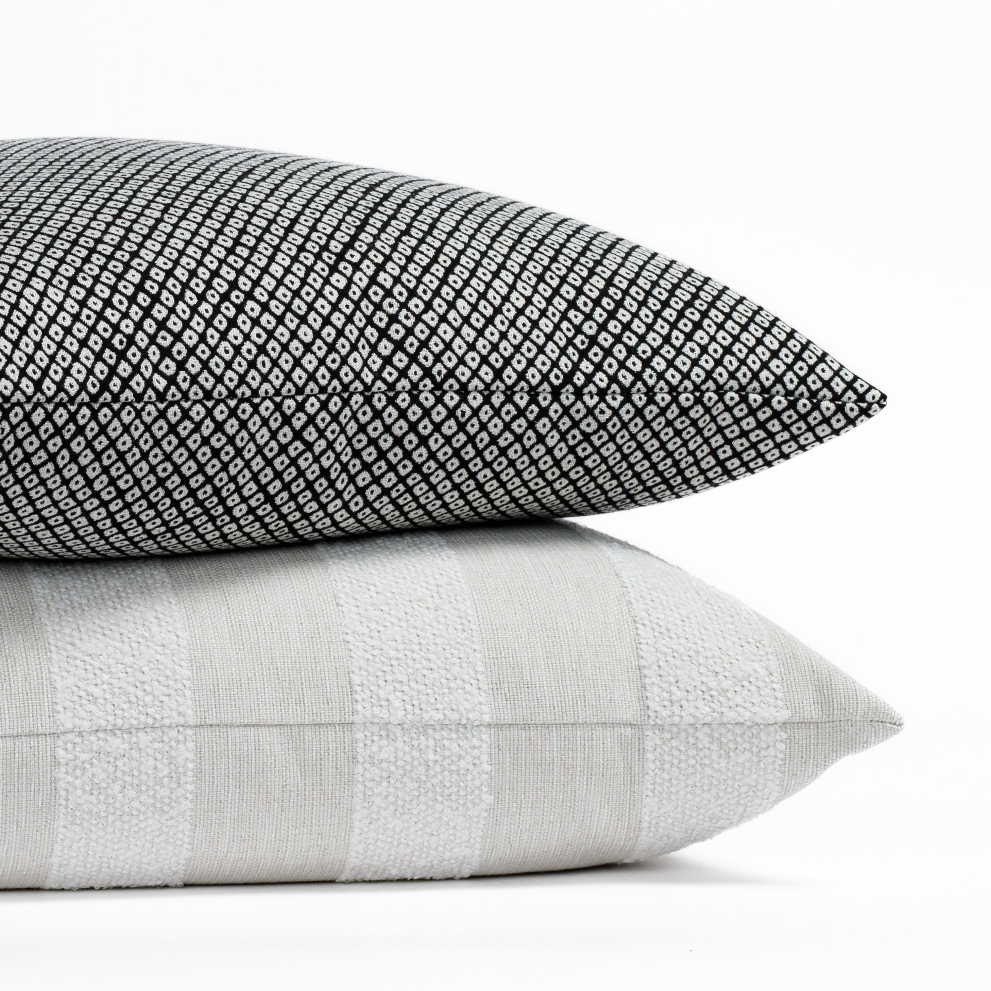 Two black and neutral toned indoor/outdoor toss pillows from Tonic Living.