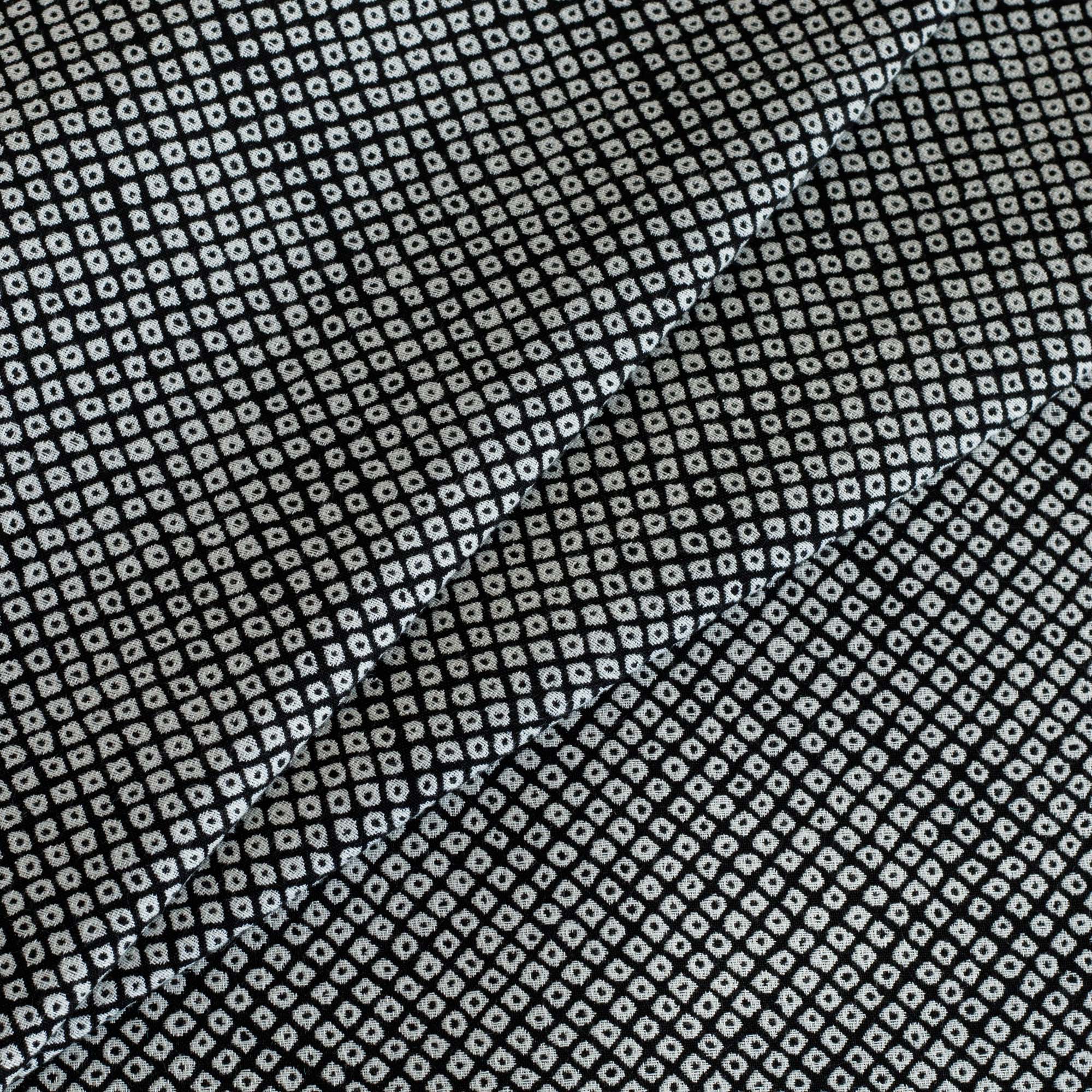 Shibori Classic, a black and white indoor/outdoor upholstery fabric with a Kanoko-style pattern of tightly arranged organic dots from Tonic Living.