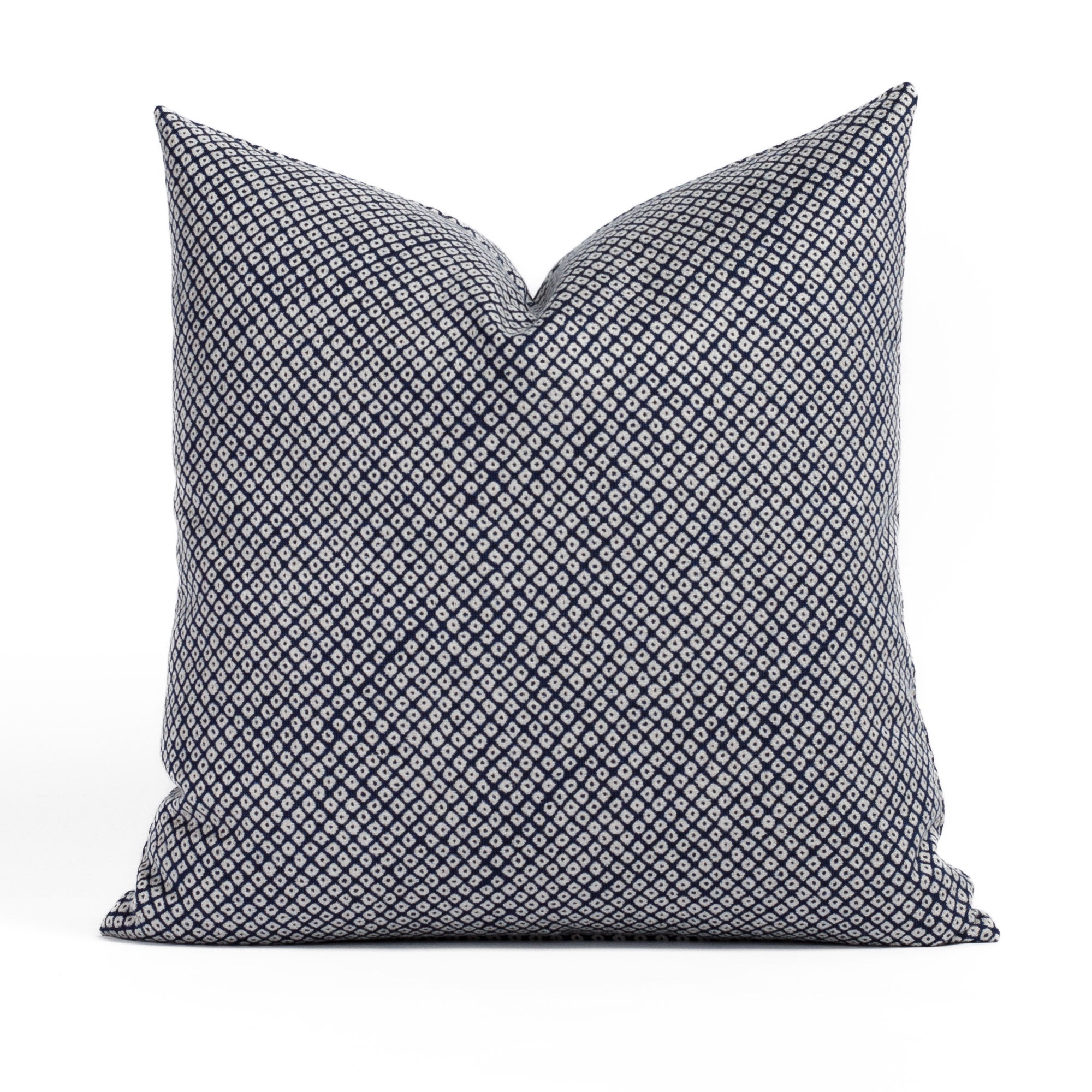 Shibori Indigo 20x20 Indoor/Outdoor Pillow from Tonic Living, a navy blue and white pillow with a Japanese-style block print pattern.