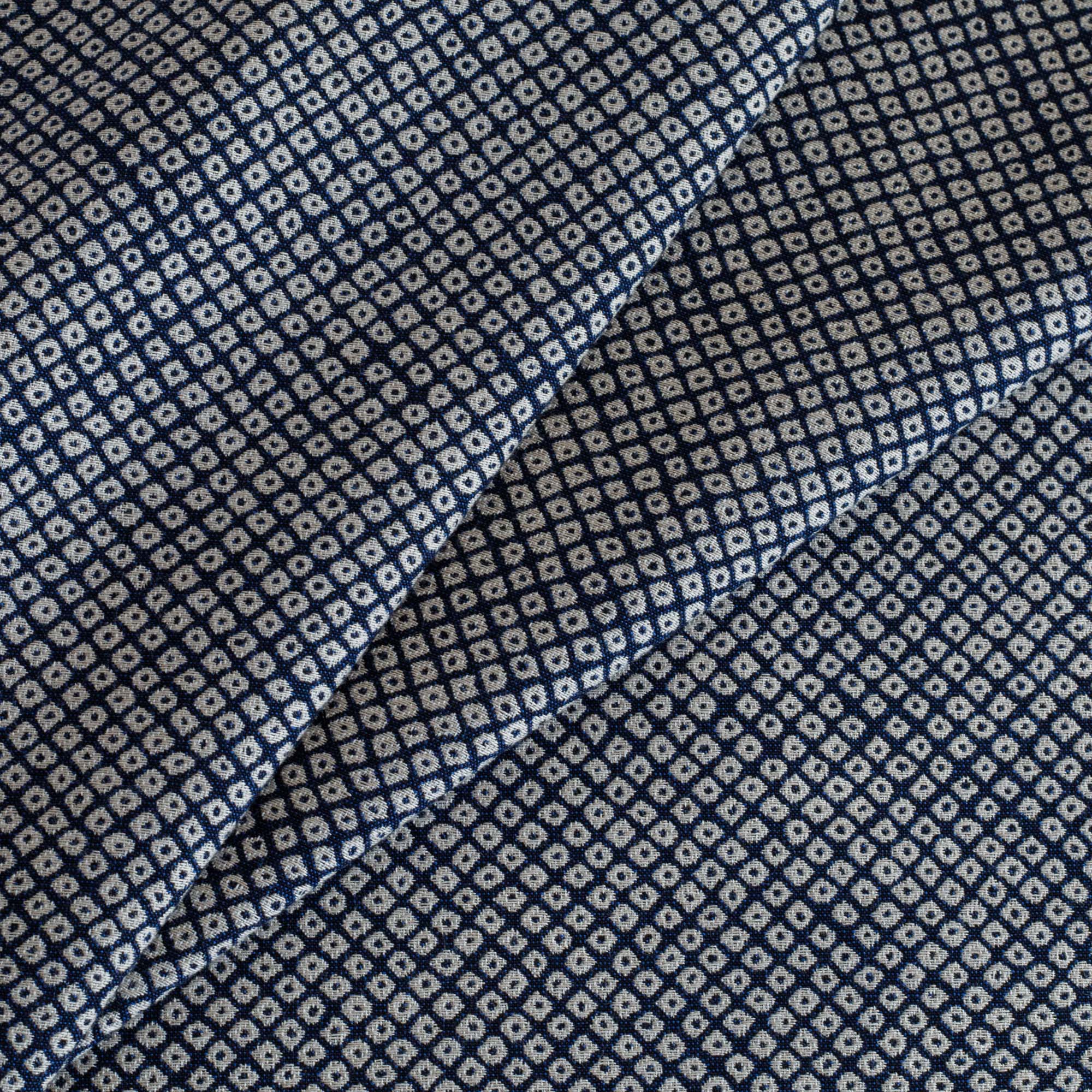 Shibori Indigo, a navy blue and white indoor/outdoor upholstery fabric with a Kanoko-style pattern of tightly arranged organic dots from Tonic Living.