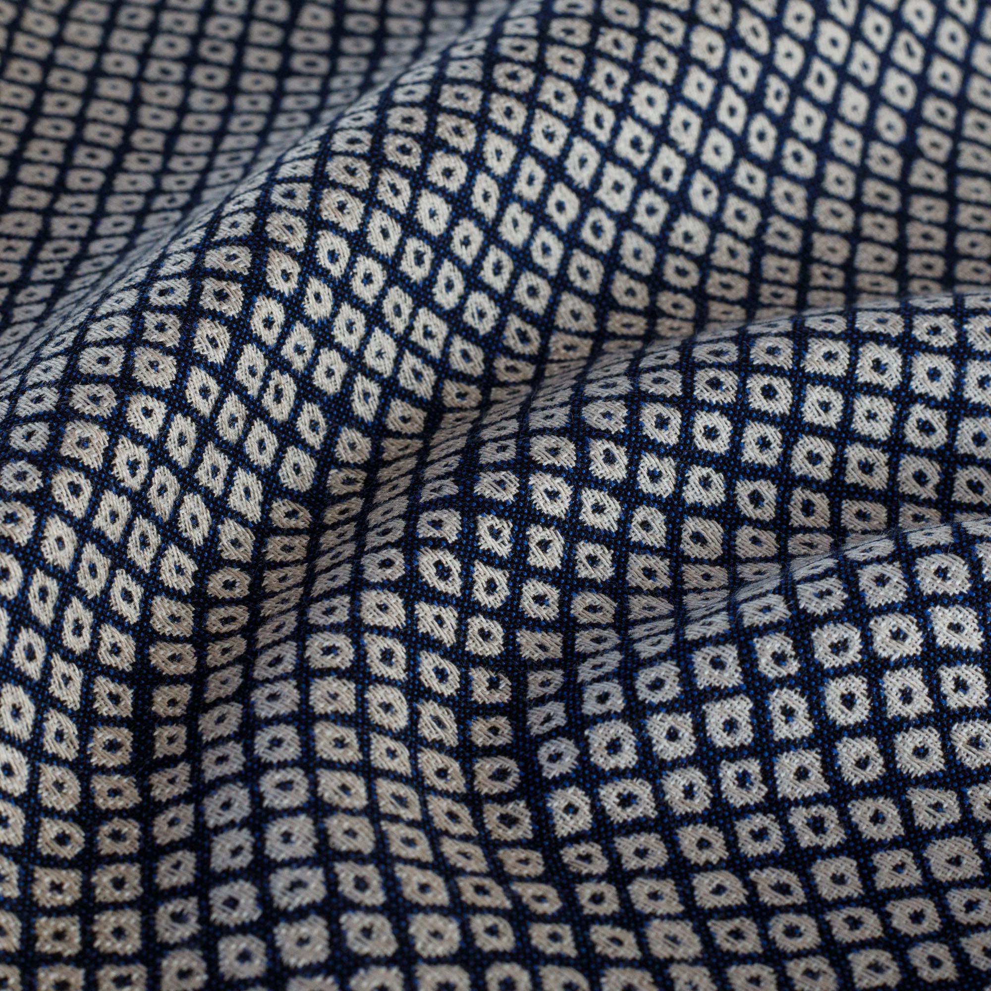 Navy blue and off-white indoor/outdoor upholstery fabric featuring a Japanese-inspired block print pattern from Tonic Living: close up view.