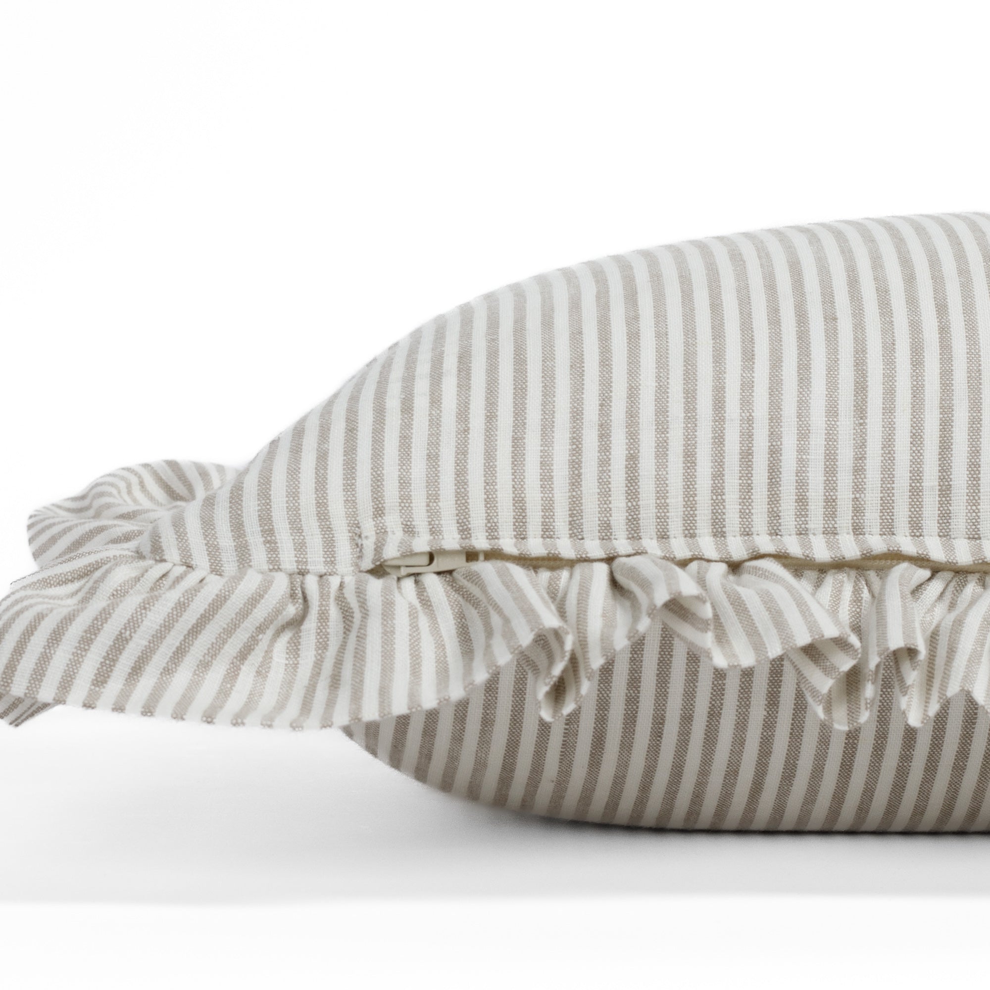 Side detail of Tonic Living’s Siena ruffle pillow with hidden zipper, emphasizing the finely finished construction and the soft beige and ivory colour combination.