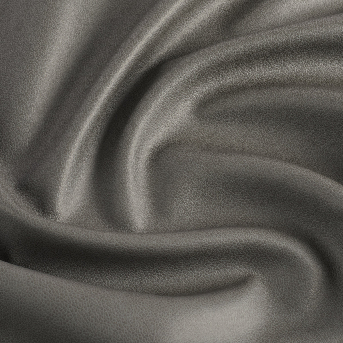 Tonic Living Smythe Faux Leather Fabric in Charcoal, a dark grey performance upholstery fabric with the rich character of genuine leather.