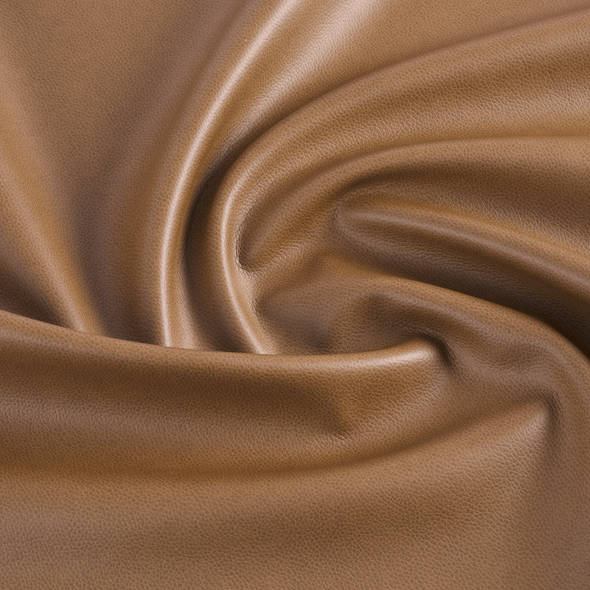 Tonic Living Smythe Faux Leather Fabric in Saddle, a brown performance upholstery fabric with the rich character of genuine leather.