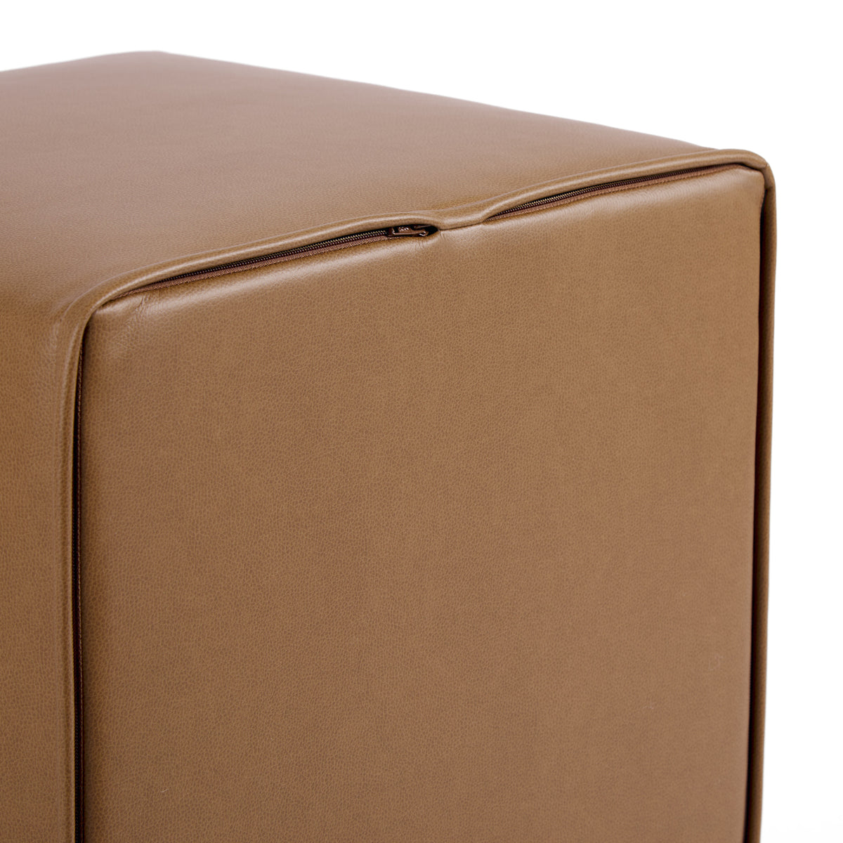 Bottom view of Tonic Living Smythe Saddle faux leather cube ottoman showing the concealed zipper and brown upholstery.