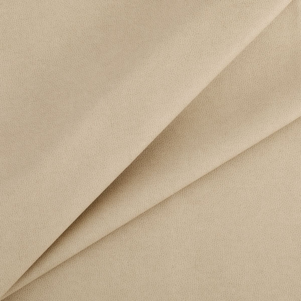Tonic Living Smythe Sandstone high-performance faux leather fabric featuring a warm neutral beige colour and natural-looking grain.