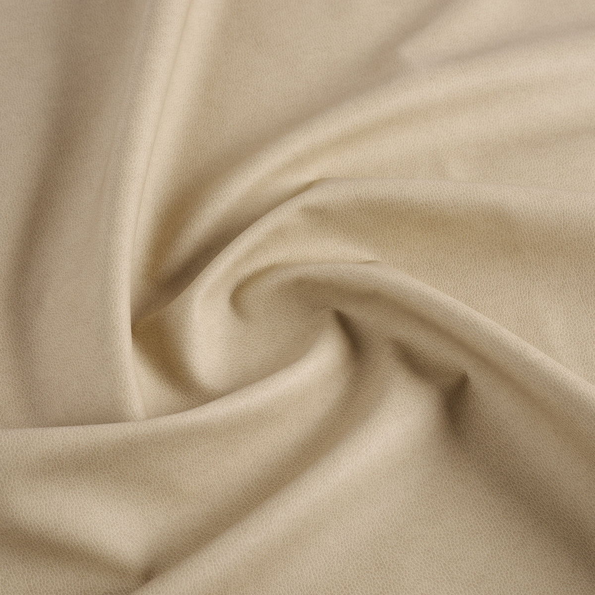 Tonic Living Smythe Faux Leather Fabric in Sandstone, a beige performance upholstery fabric with the rich character of genuine leather