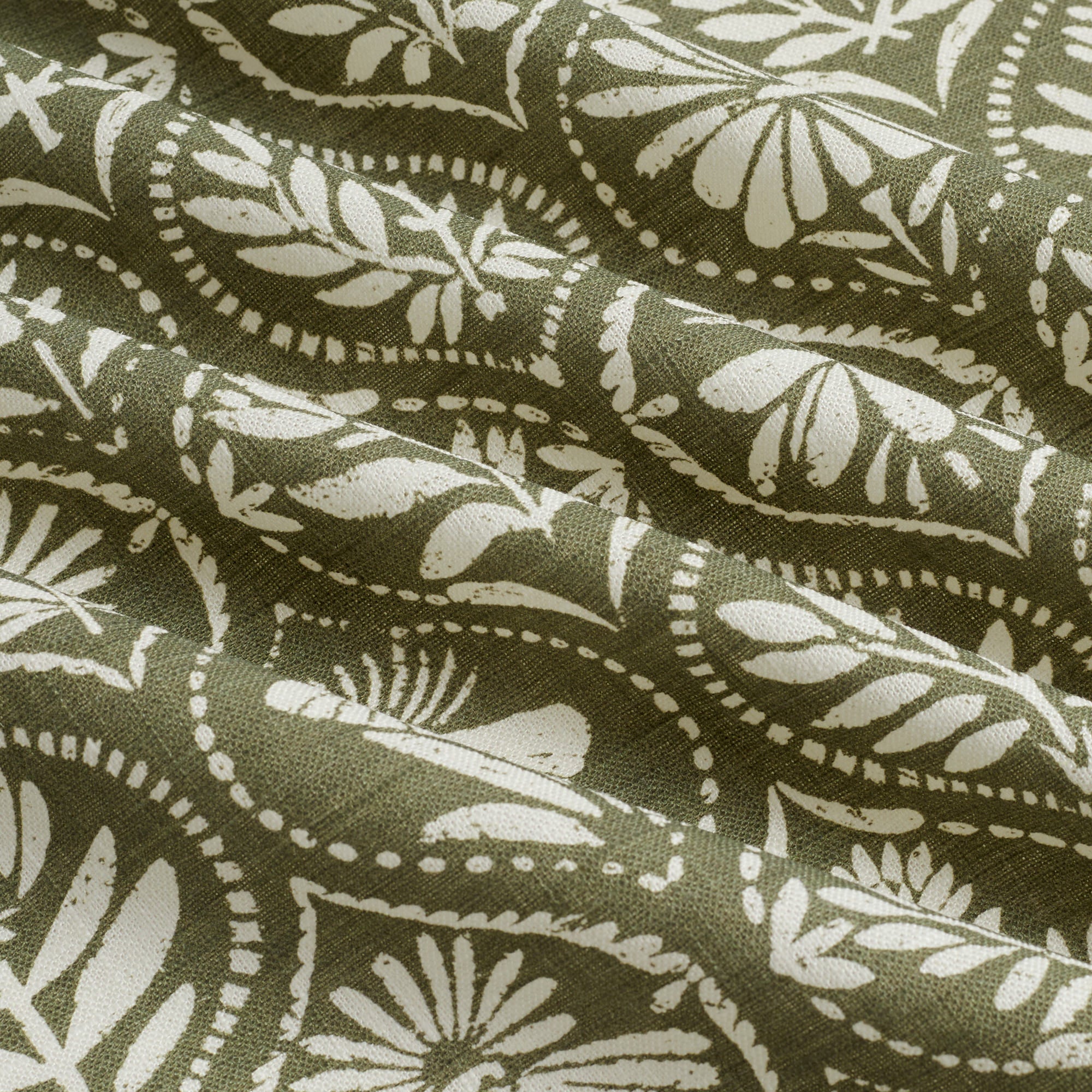 Tonic Living Stella Evergreen drapery fabric shown with movement highlighting dark green and beige medallion pattern.