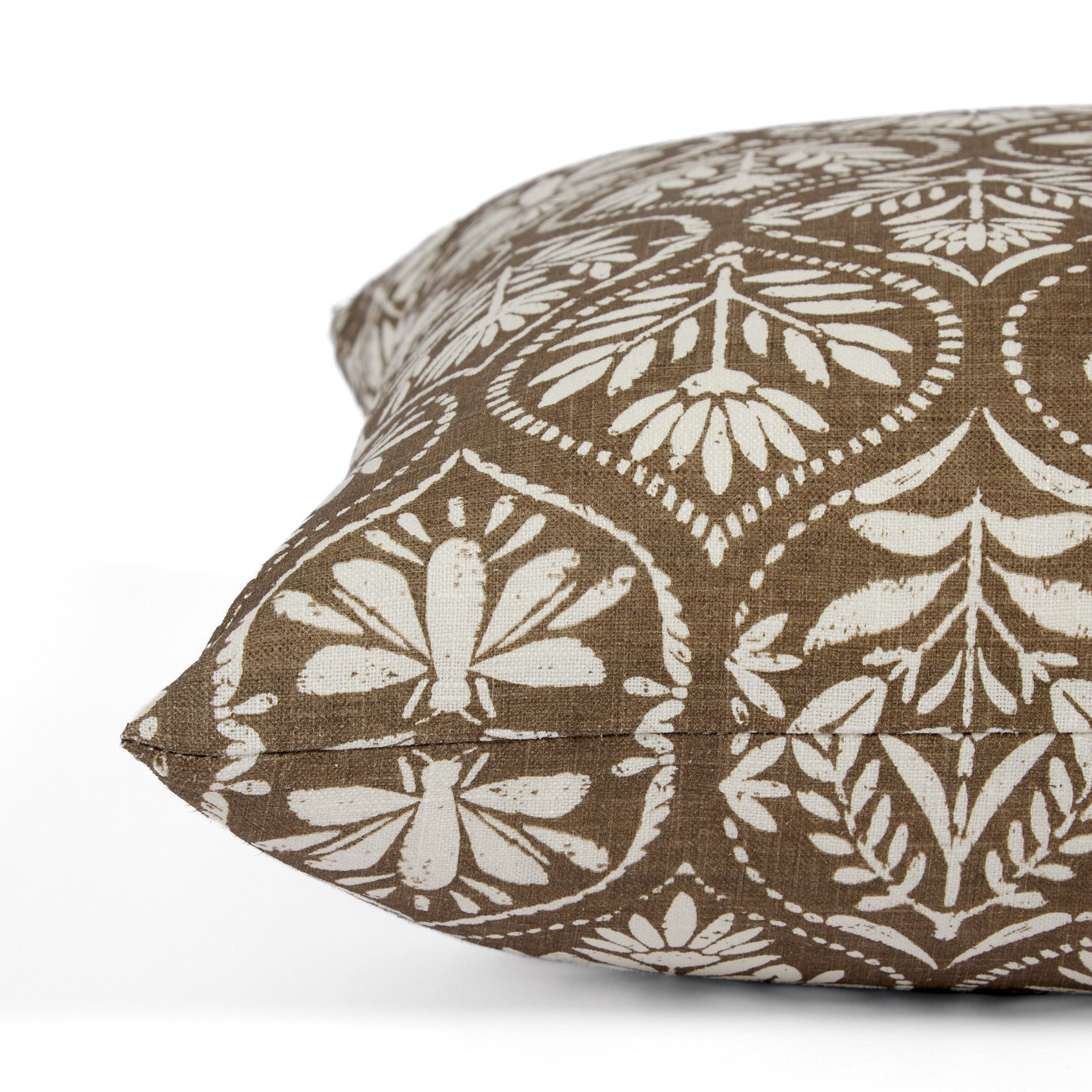 Side view of Tonic Living Stella Mocha decorative pillow highlighting its floral block print medallion pattern.