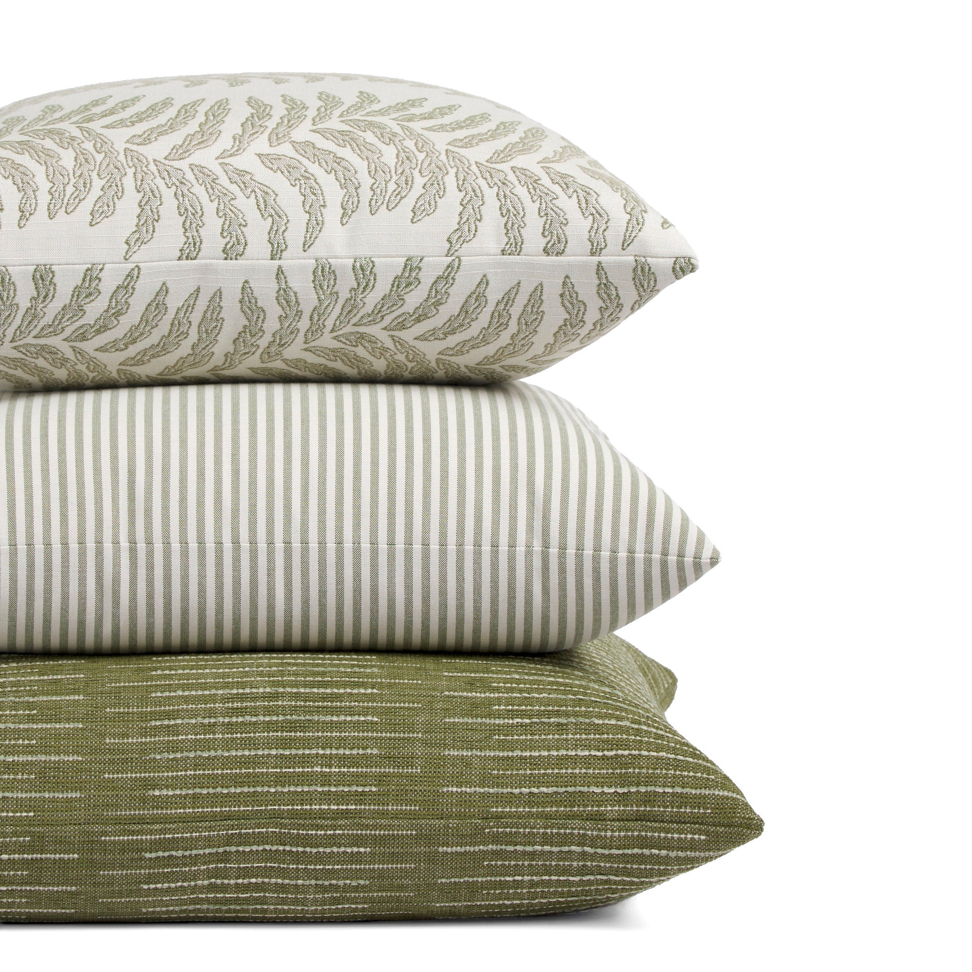 Stack of Tonic Living outdoor pillows including Swoon Sage, Refresh Hedge, and Hawthorne in green striped designs.