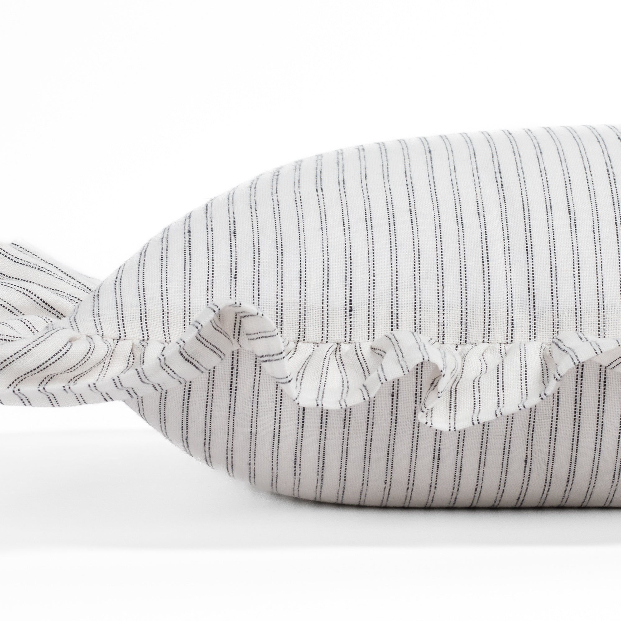 Side close-up of the Verona 14x20 ruffle pillow by Tonic Living, showing the layered ruffle edge and pinstripe detail in creamy white and jet black.