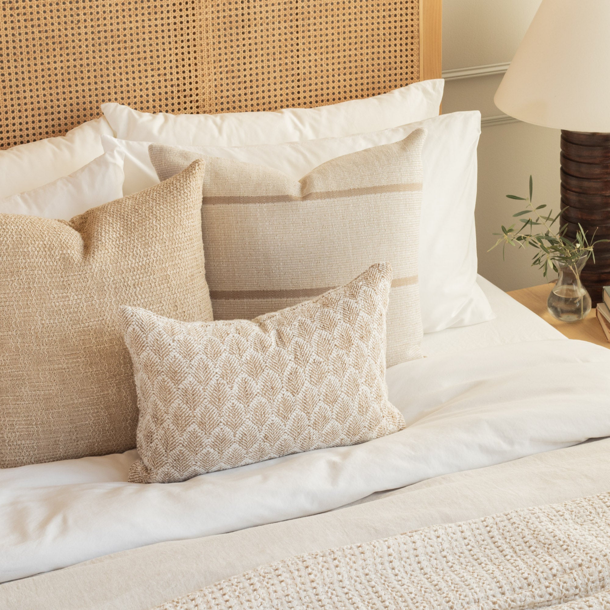 Bedroom styled with neutral beige textured throw pillows from Tonic Living