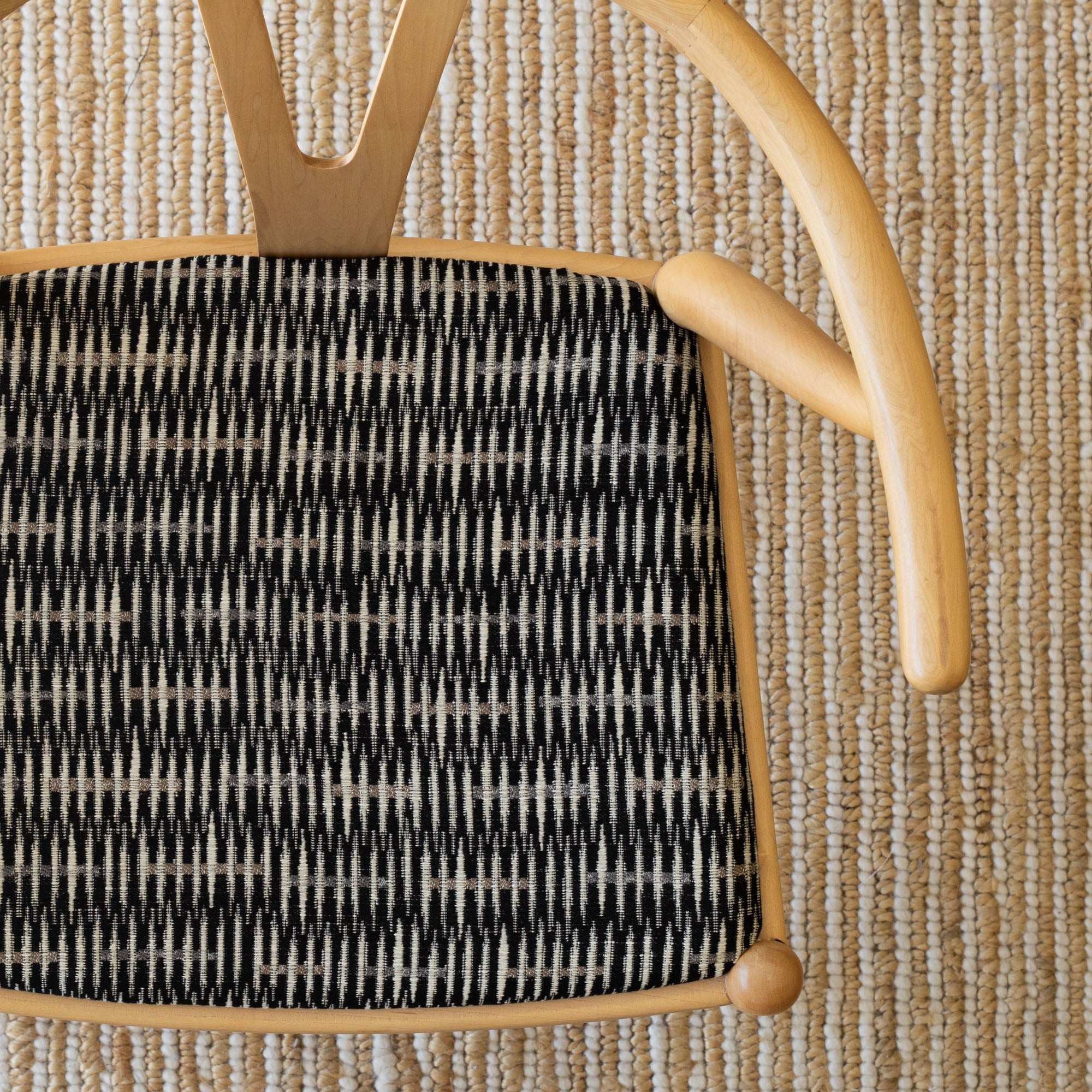 a graphic black, brown and tan upholstered chair 