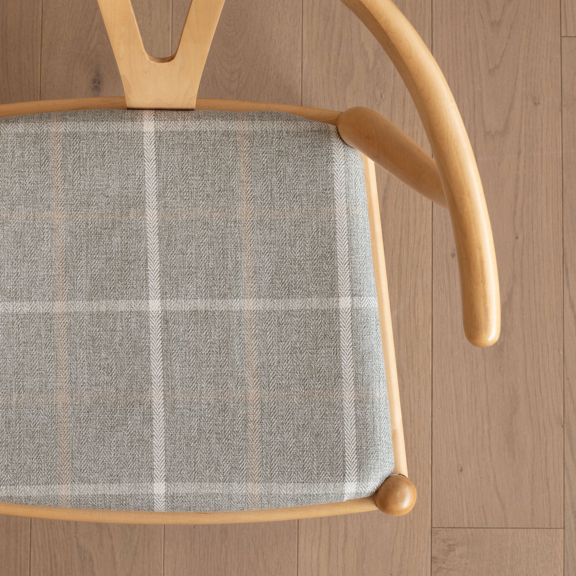 A classic light gray and beige plaid upholstery fabric dining chair seat