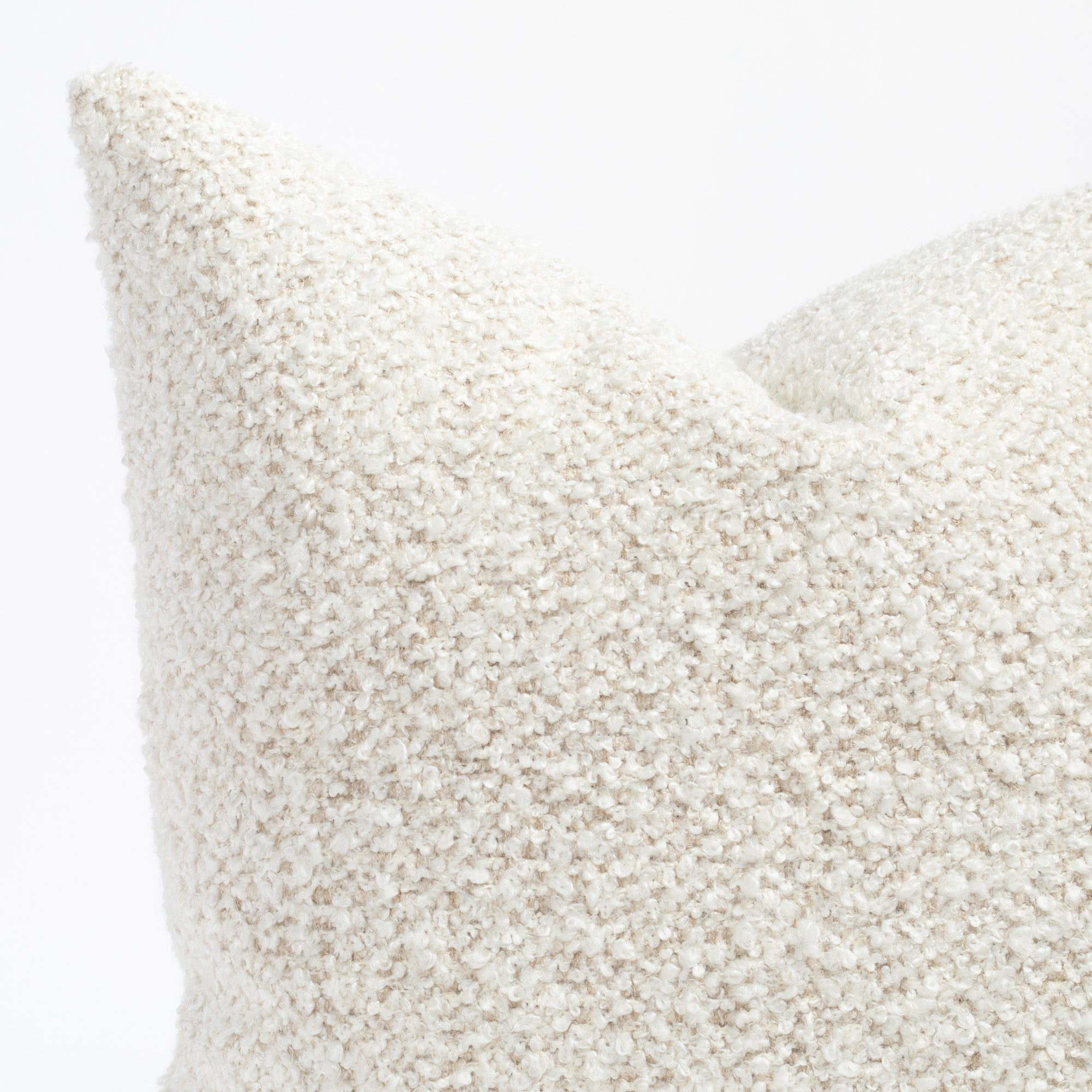 A cream boucle throw pillow