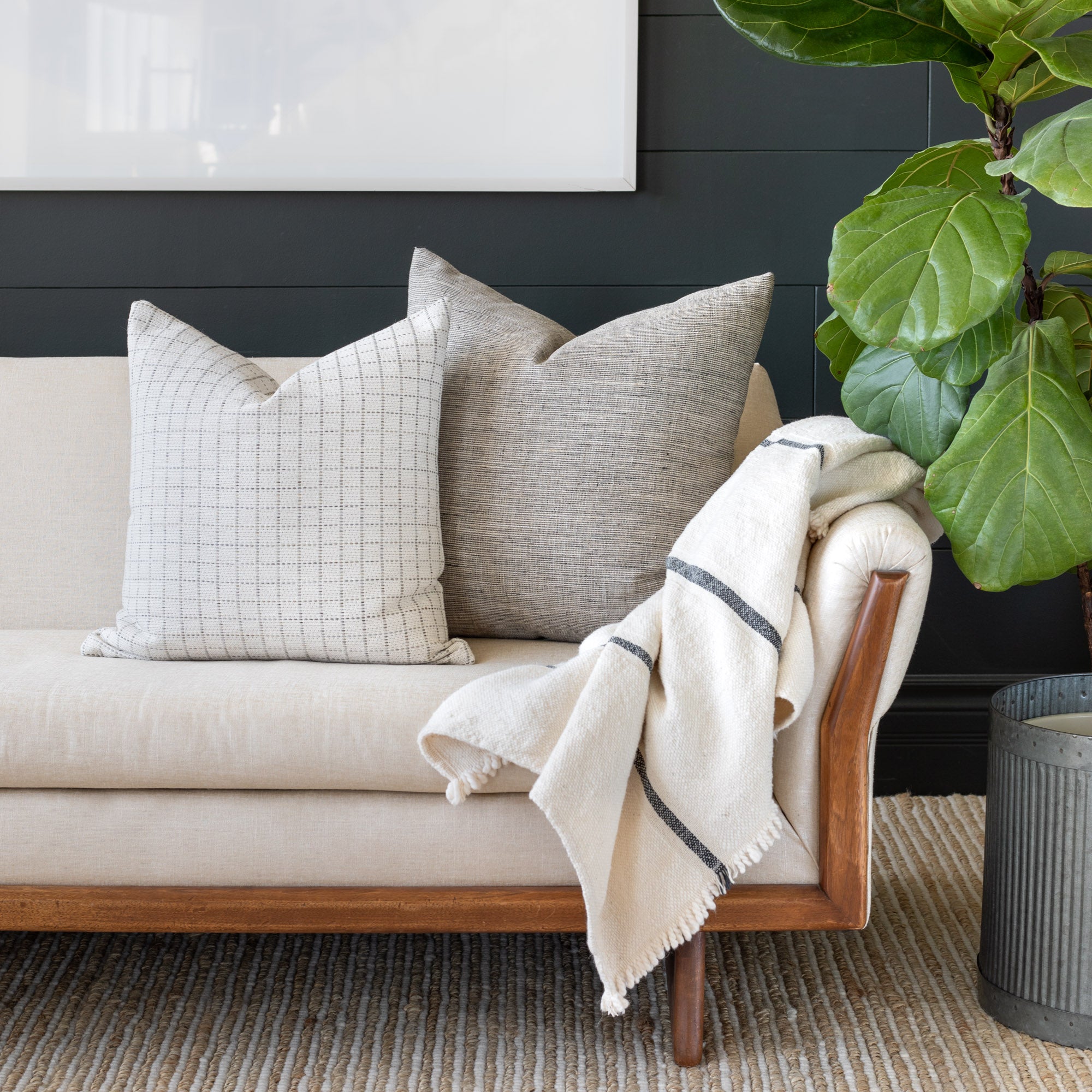 Neutral Sofa Vignette: Keely Check Birch and Stanhope Ash pillow and Rafael Cream throw blanket