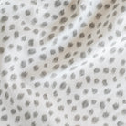 a white and silver gray inky polka dot print fabric