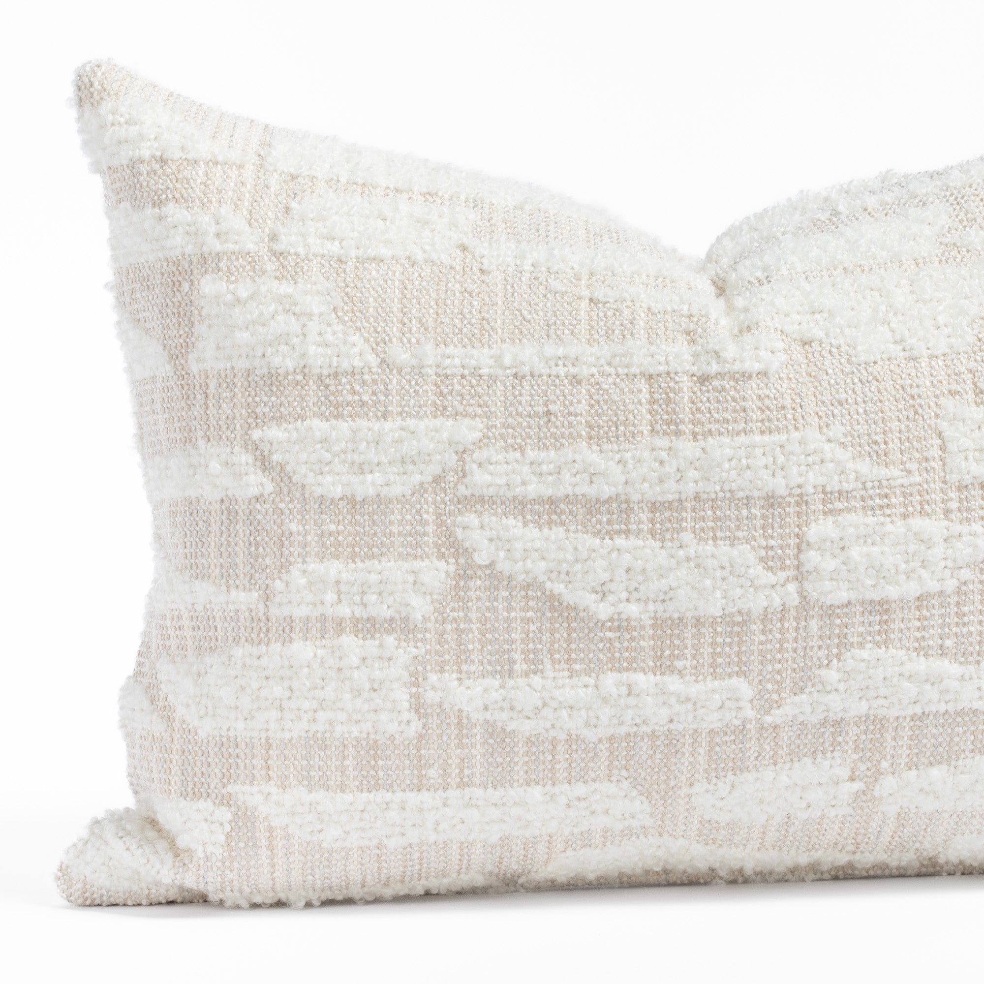 a cream textured abstract patterned lumbar throw pillow : close up view