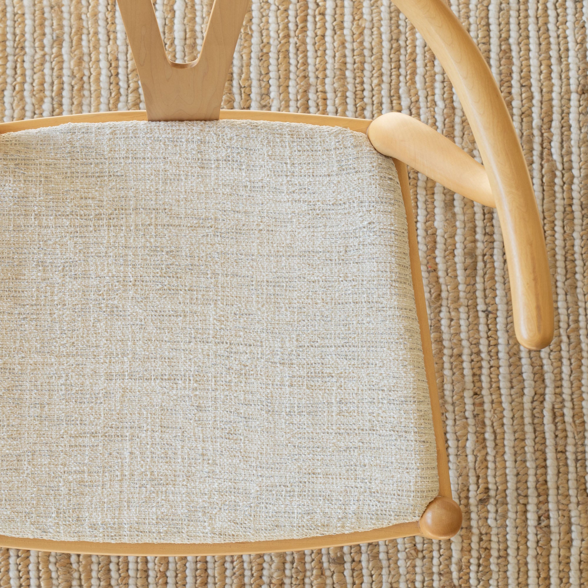 a sandy beige upholstered chair seat