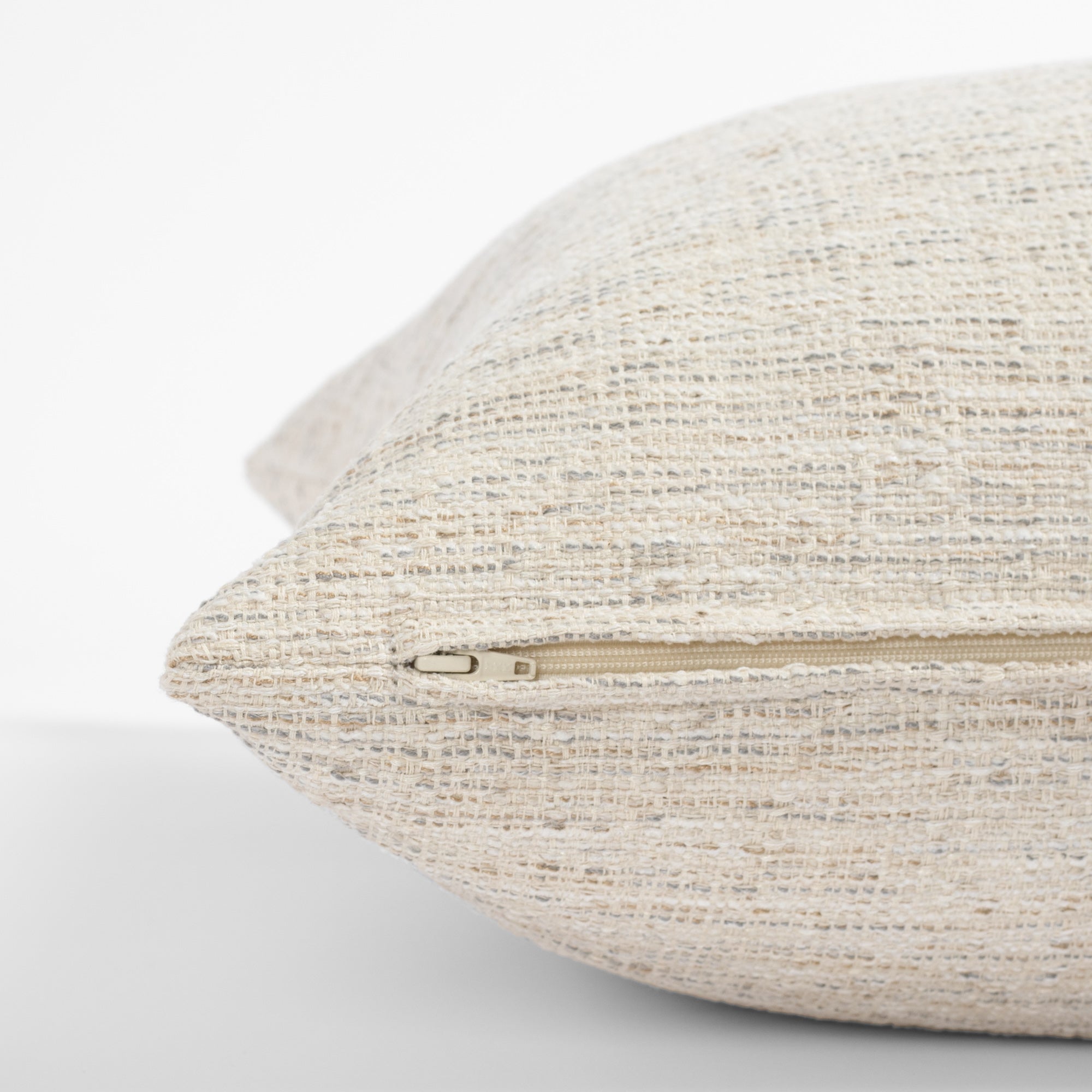 a cream beige textured throw pillow - zipper detail