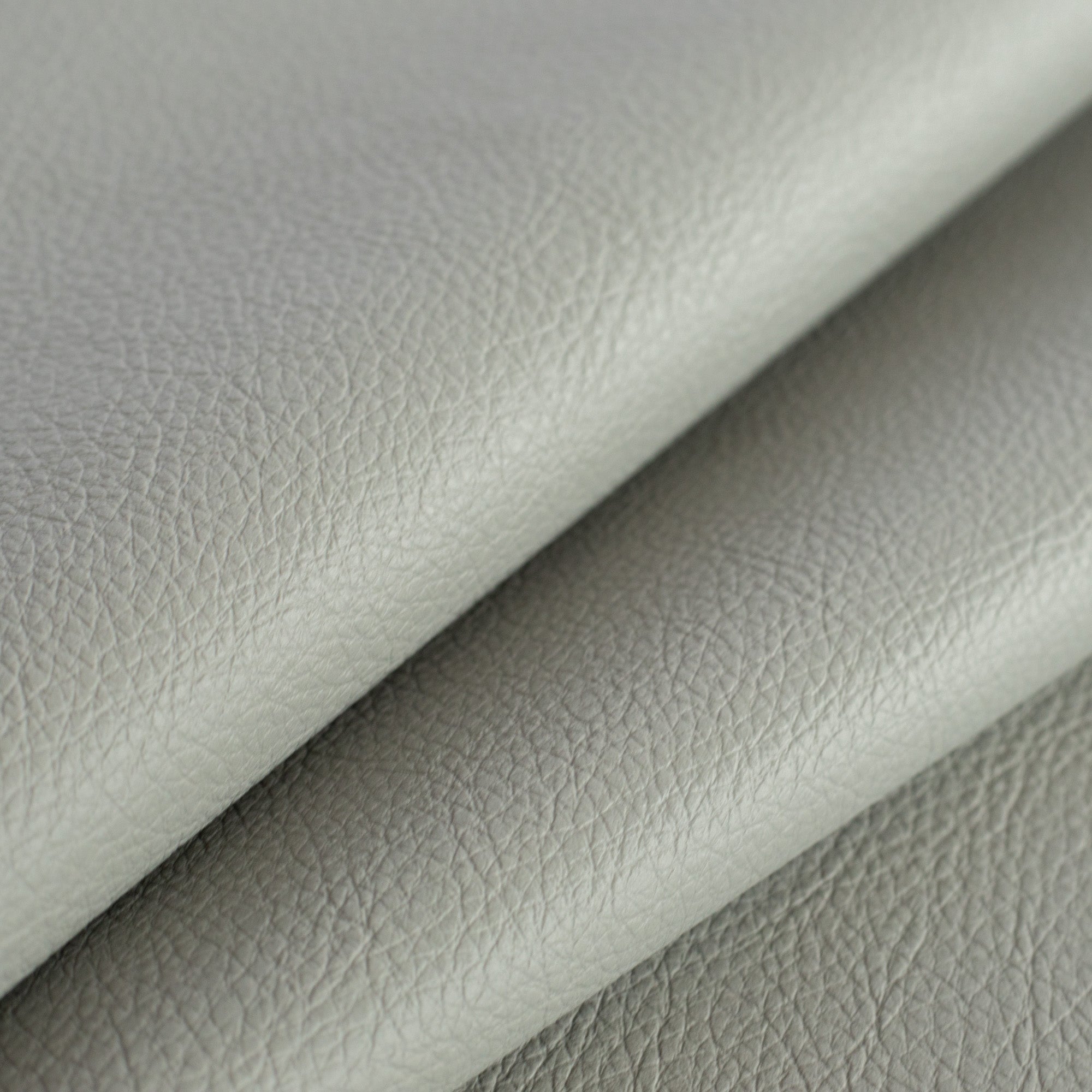 a gray vinyl performance upholstery fabric : close up view