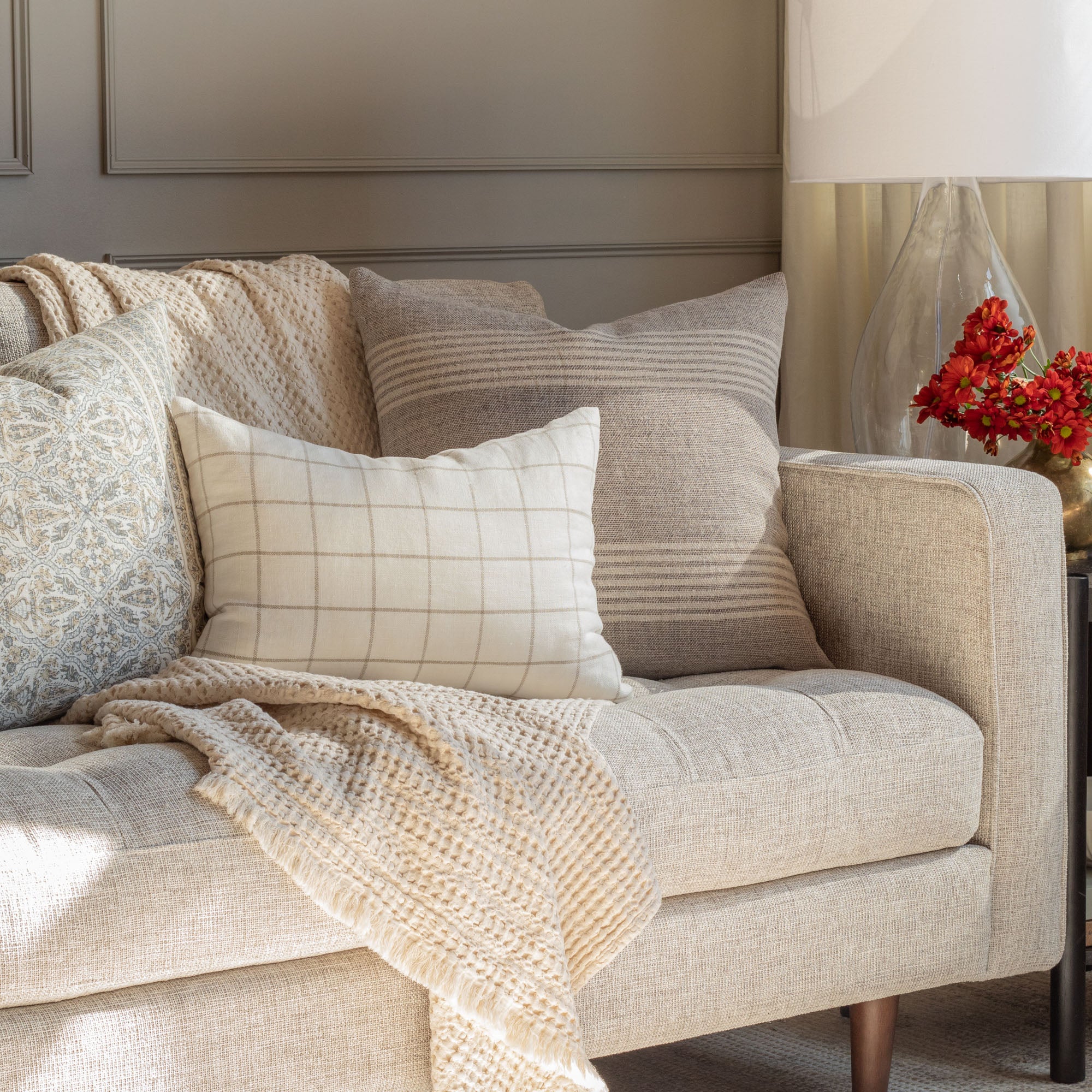 Living room scene with textures and patterns in neutral colours - Stockton Graphite, Butler natural cream and lasha natural