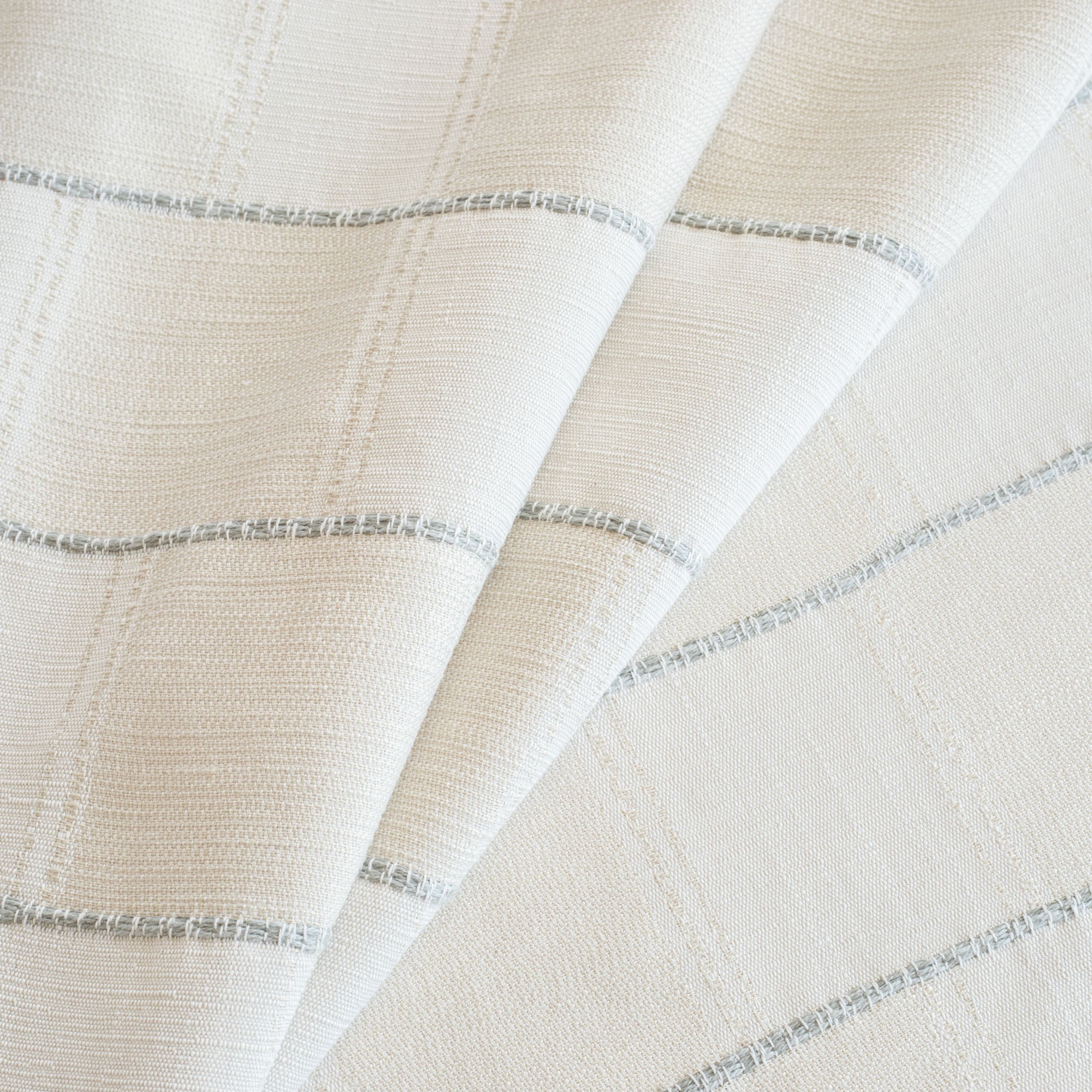 a cream and off white check fabric with a chunky light blue horizontal stripe