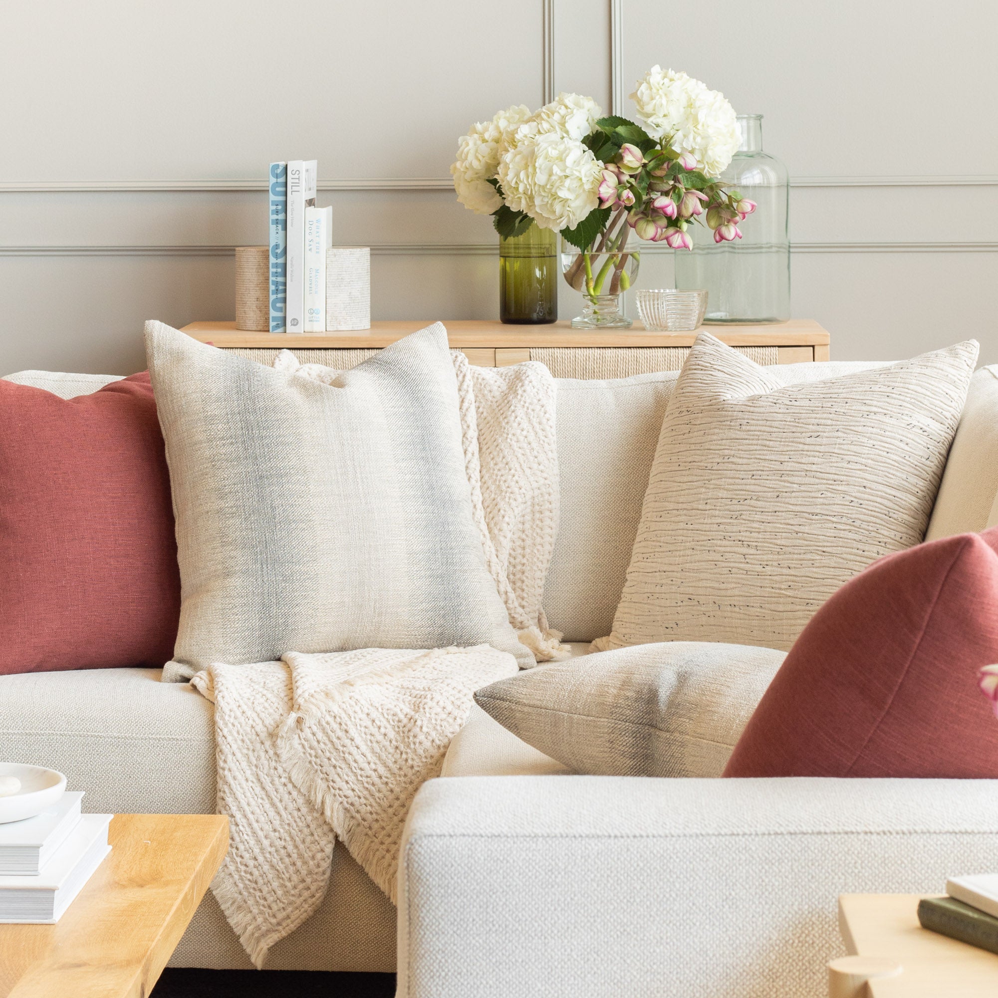 Tonic Living pillow on a cream sectional : modern decorative throw pillows in neutral cream and muted blue greys