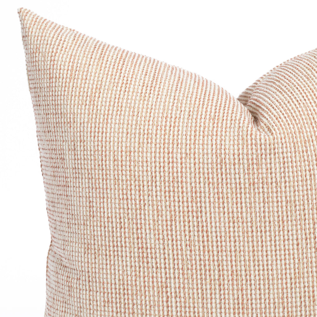 a terracotta pink and taupe textured outdoor pillow : close up view