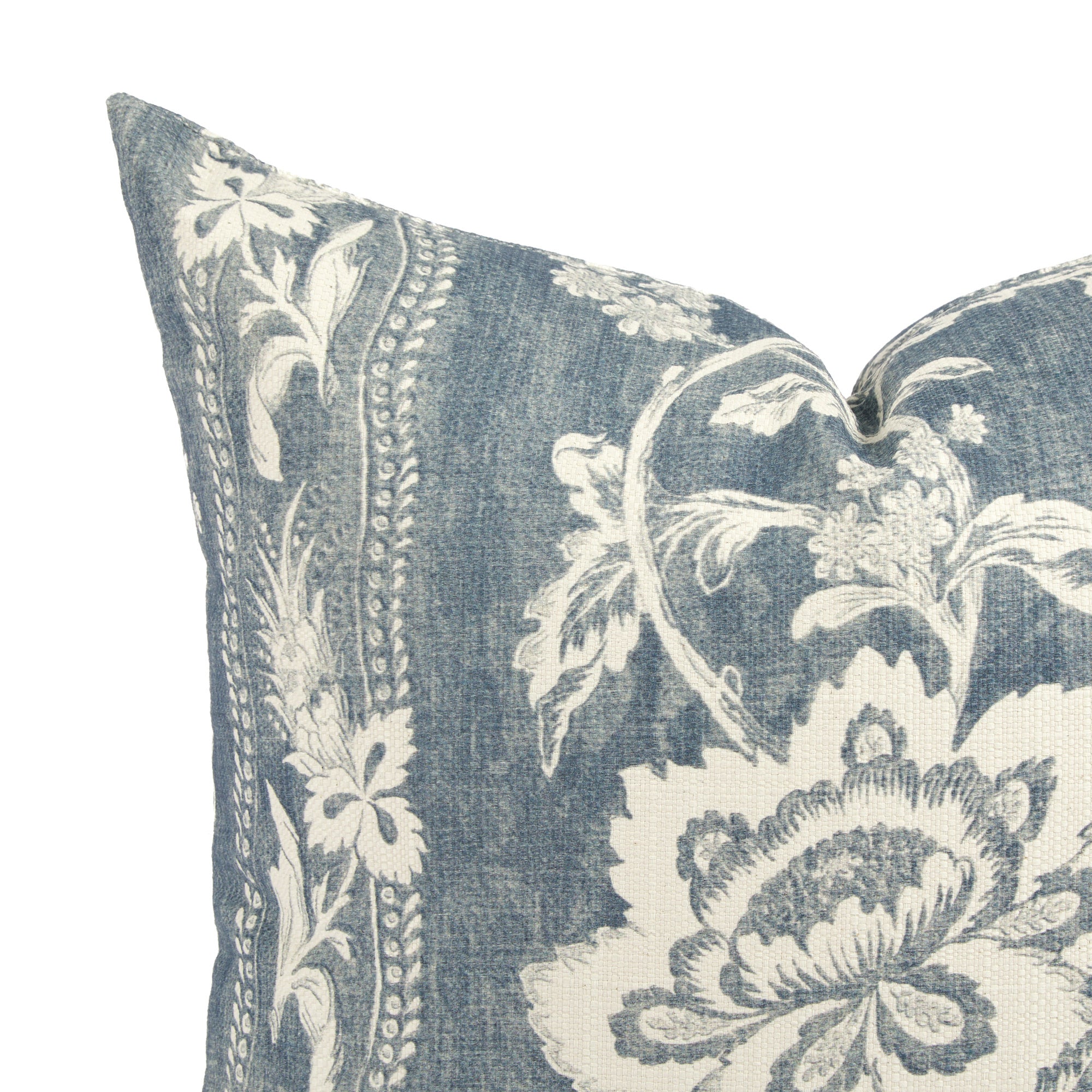 Close up of Tonic Living Ashford cushion showing scrolling floral vine detail in chambray blue and white.