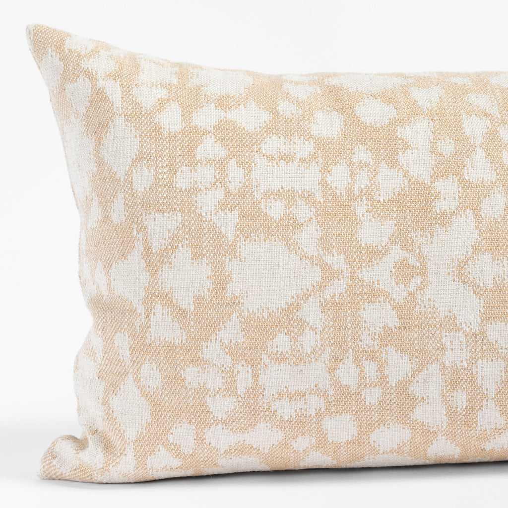 a soft gold and cream abstract floral patterned lumbar throw pillow: close up view